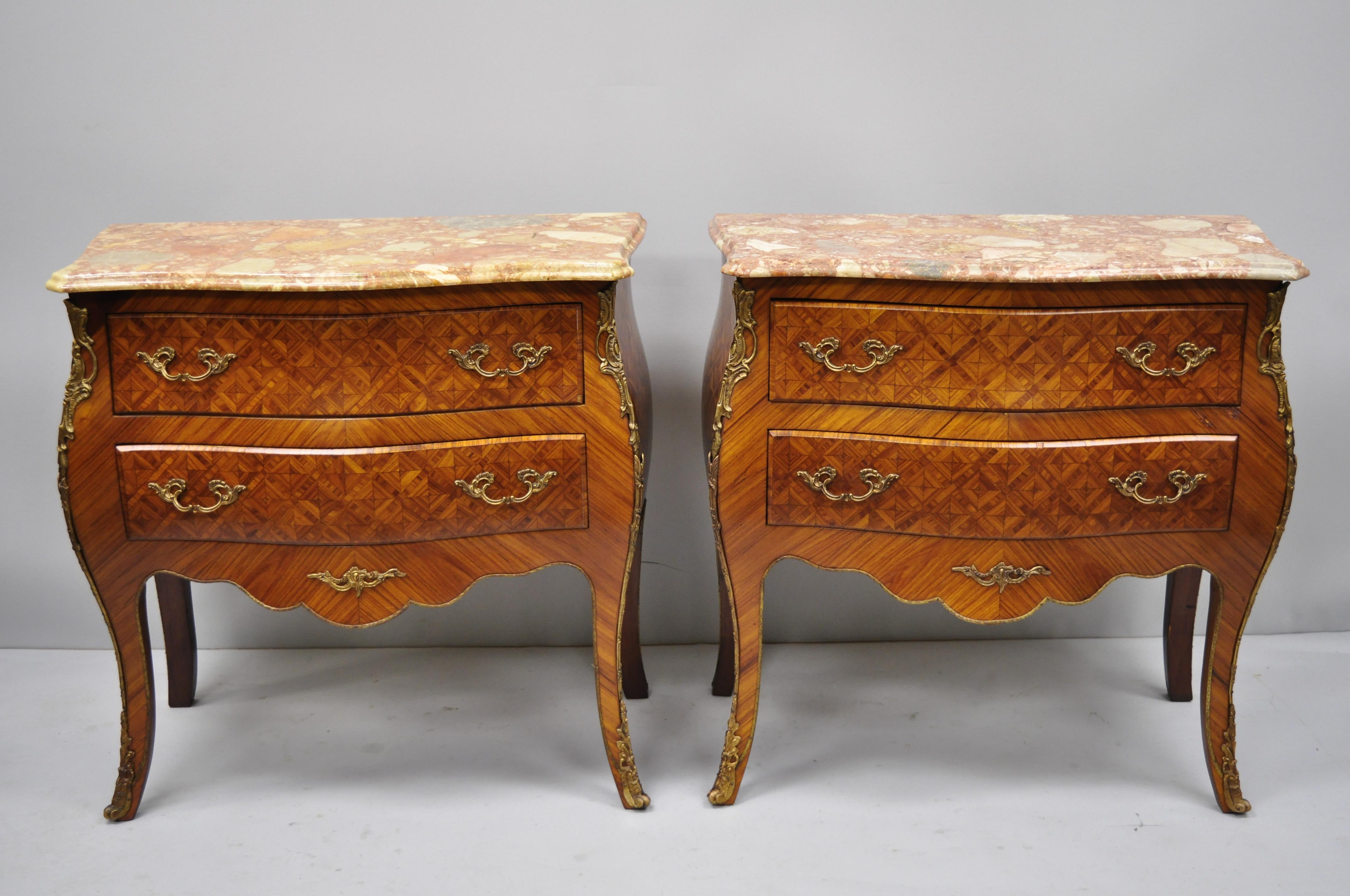 Pair of French Louis XV style pink marble-top inlaid bombe commode chests. Items include pink marble tops, beautiful parquetry inlay, bronze ormolu, shapely bombe form, 2 dovetailed drawers, cabriole legs, great style and form, circa late 20th