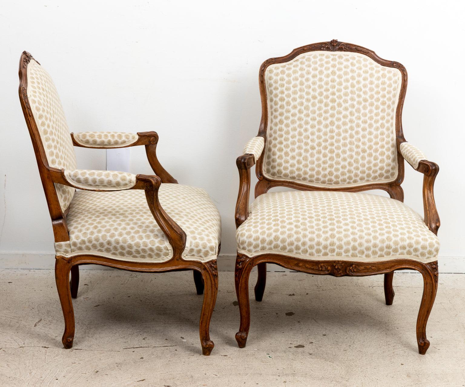 Pair of French Louis XV carved and upholstered fauteuils. Please note of wear consistent with age.