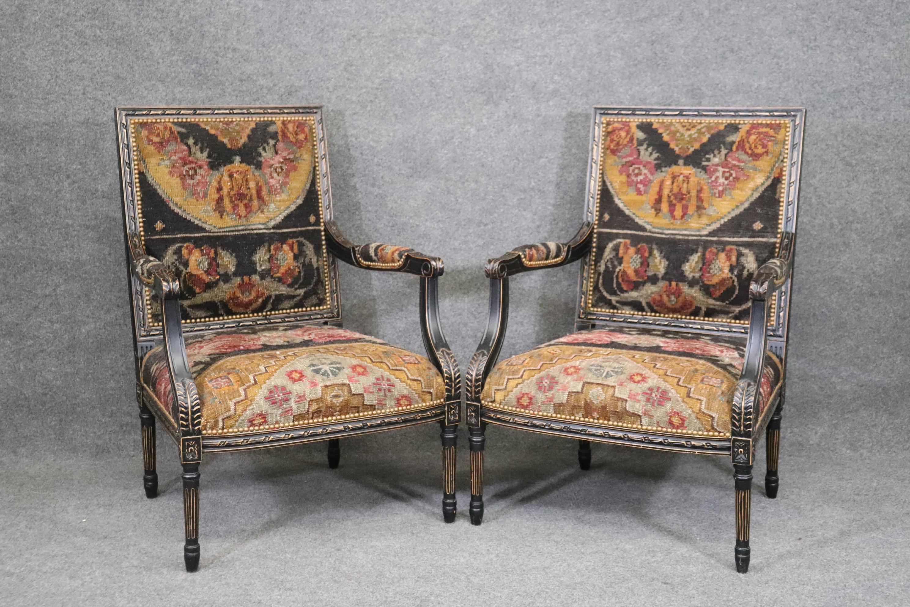 This is a gorgeous pair of American made French Louis XVI style distressed ebony finished armchairs. They are quite beautiful because they used what appears to be oriental rug pieces for upholstery to add interest and make them stand out from the