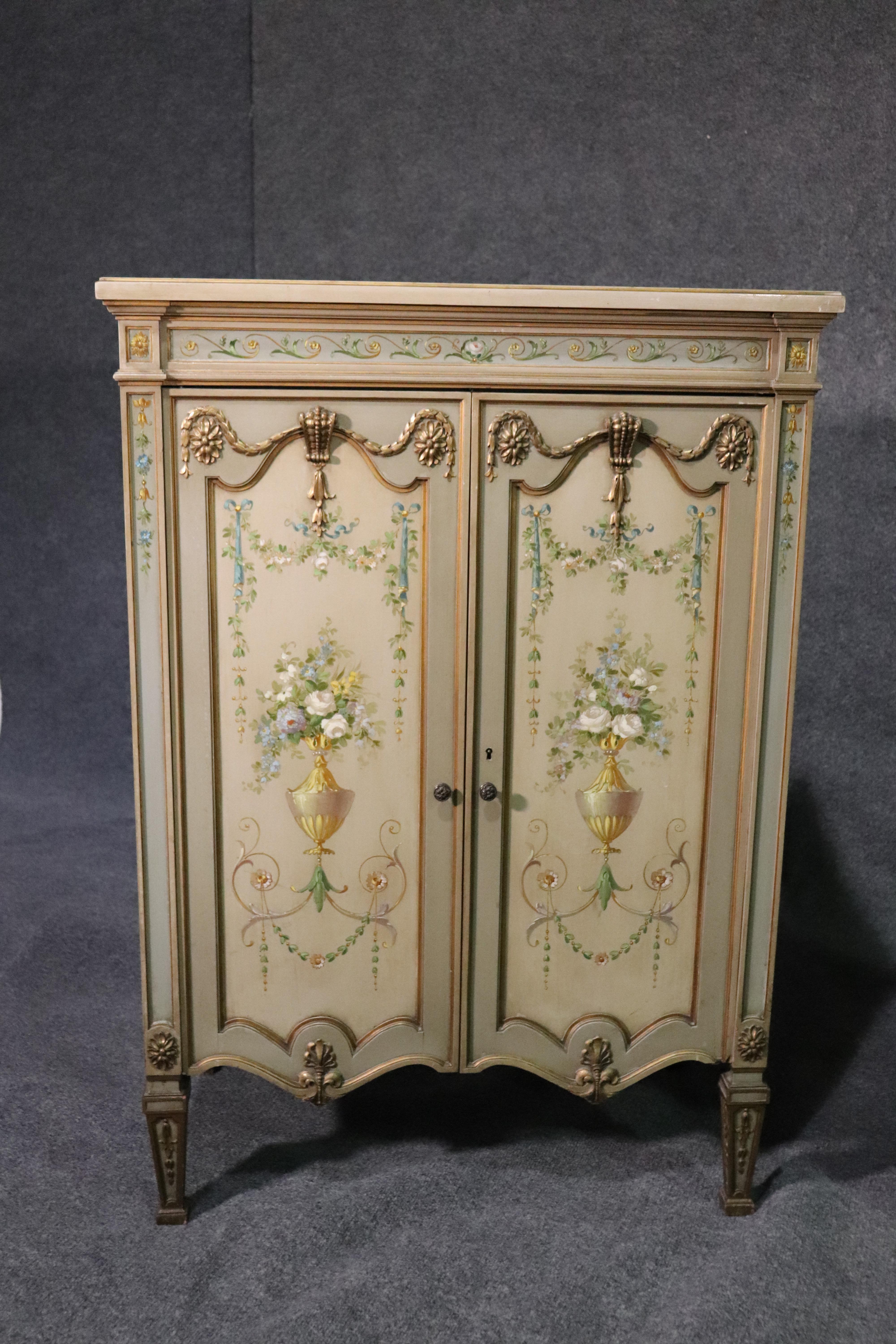 This is a fine pair of French carved side cabinets. Perfect for an entryway or foyer, these cabinets are very rare and unique and have superb details including exceptional paint decorated doors and carved details. The tops are good too save for one