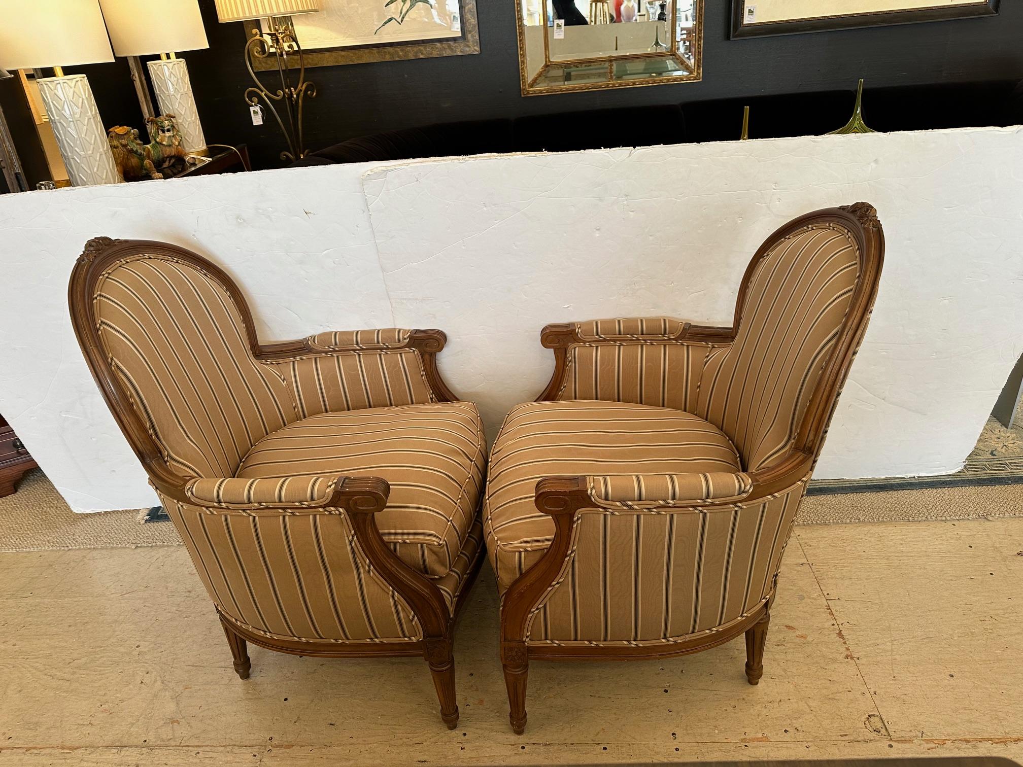 Pair of elegant French Louis XVI style bergeres having carved wood frames and new striped silk moire upholstery. 
Arm    24” H


