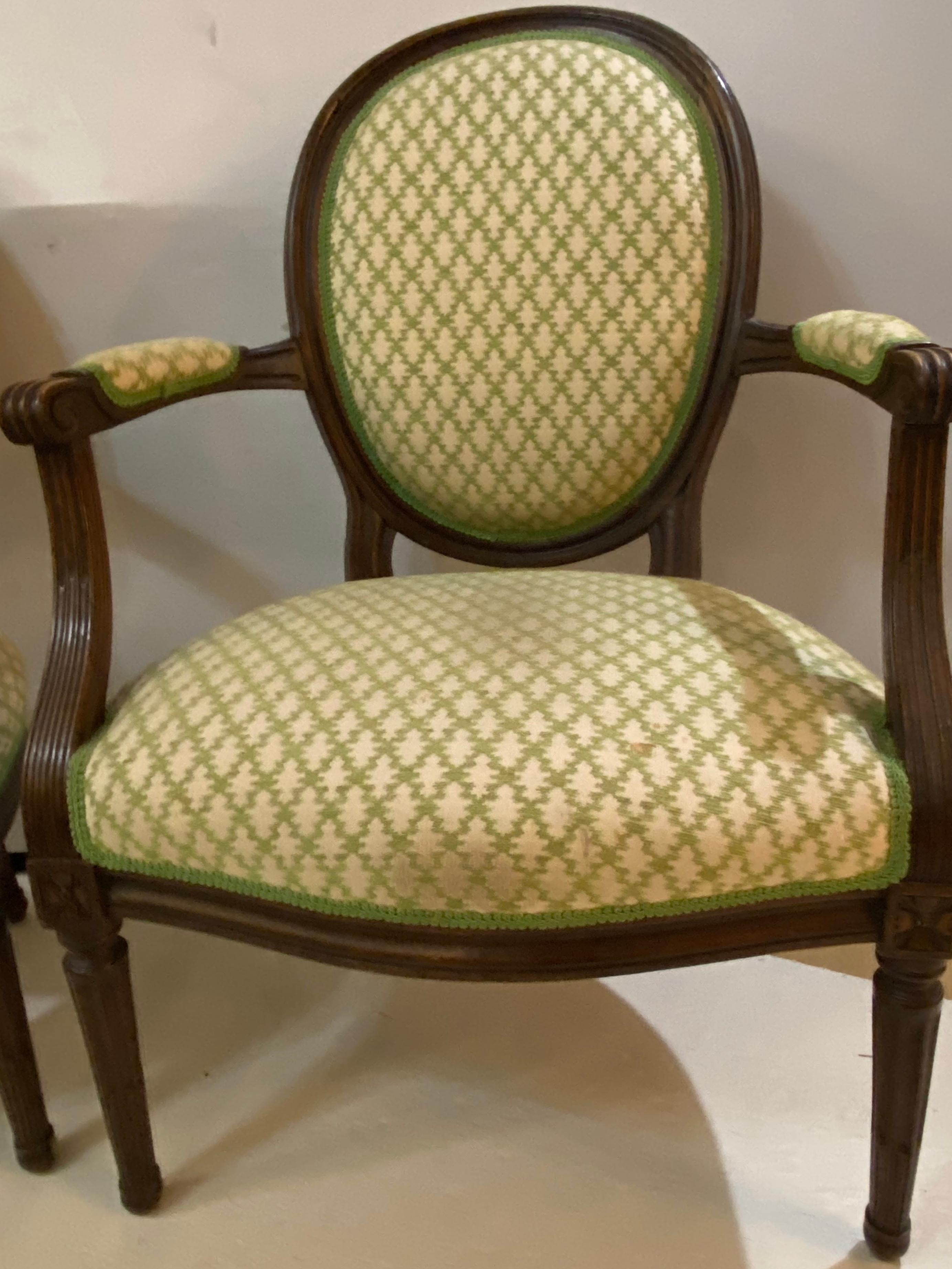 Pair of French Maison Jansen bergeres or armchairs in walnut. Stamped JANSEN on the bottoms and fashioned in the Louis XVI style these simple and stylish armchairs can support the look of any living area and would be lovely in front and back of a