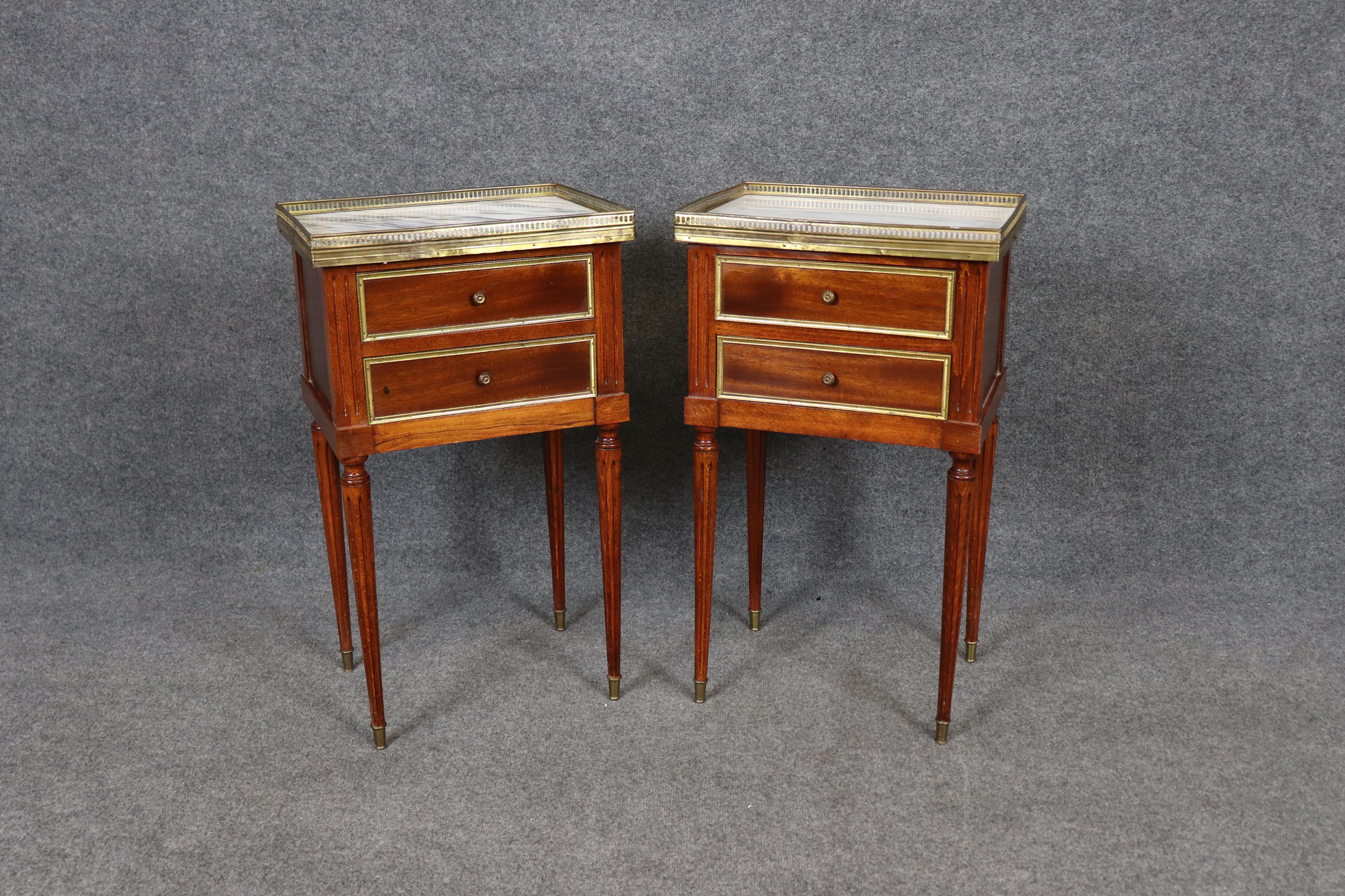 
This elegant pair of French Louis XVI style nightstands, attributed to the Maison Jansen tradition, beautifully blends refined neoclassical design with timeless functionality. Each stand features a rectangular form with clean lines, finely tapered