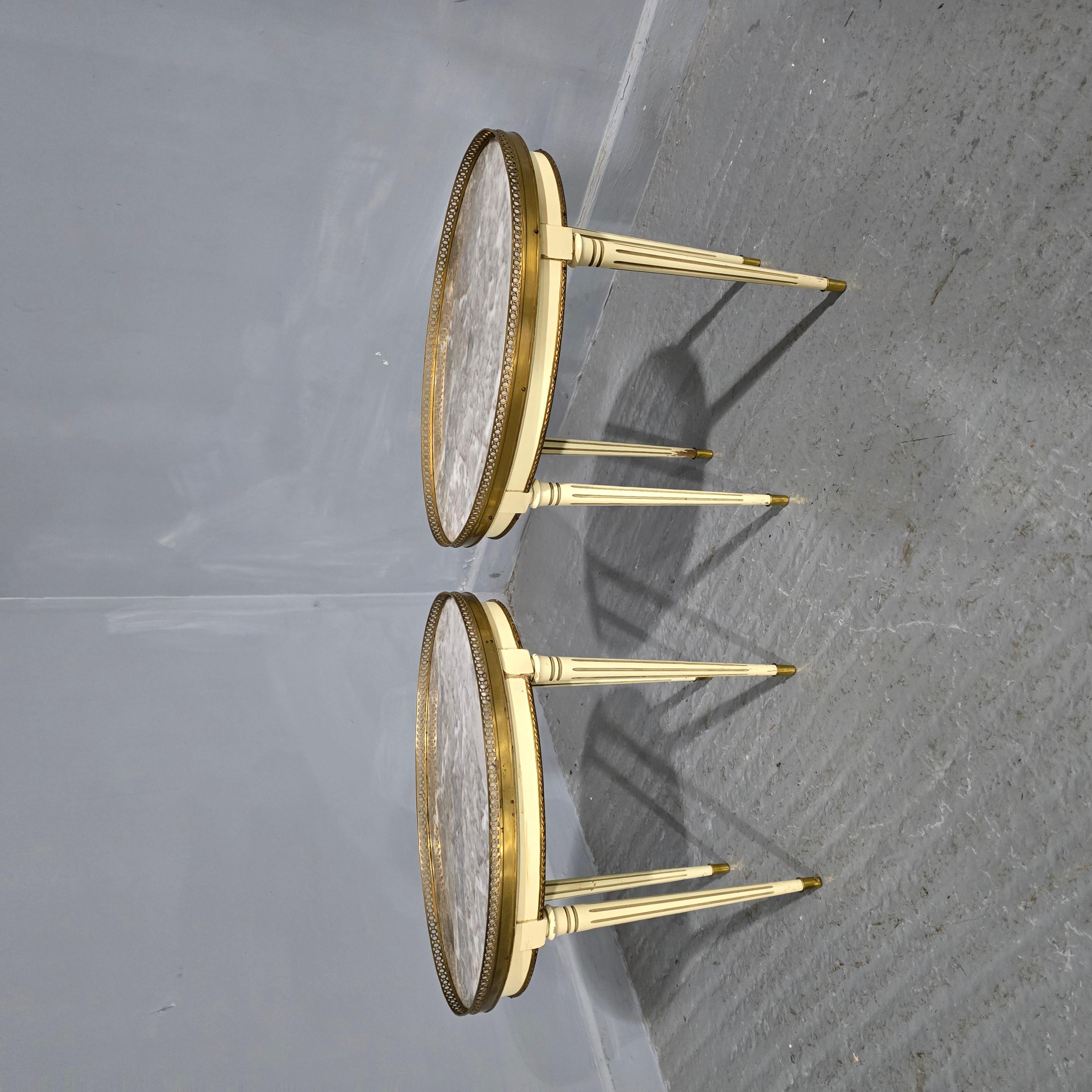 A good pair of French painted lamp tables with grey verigated marble tops surrounded by brass galleries, brass tipped legs, in overall very good condition.

17.75