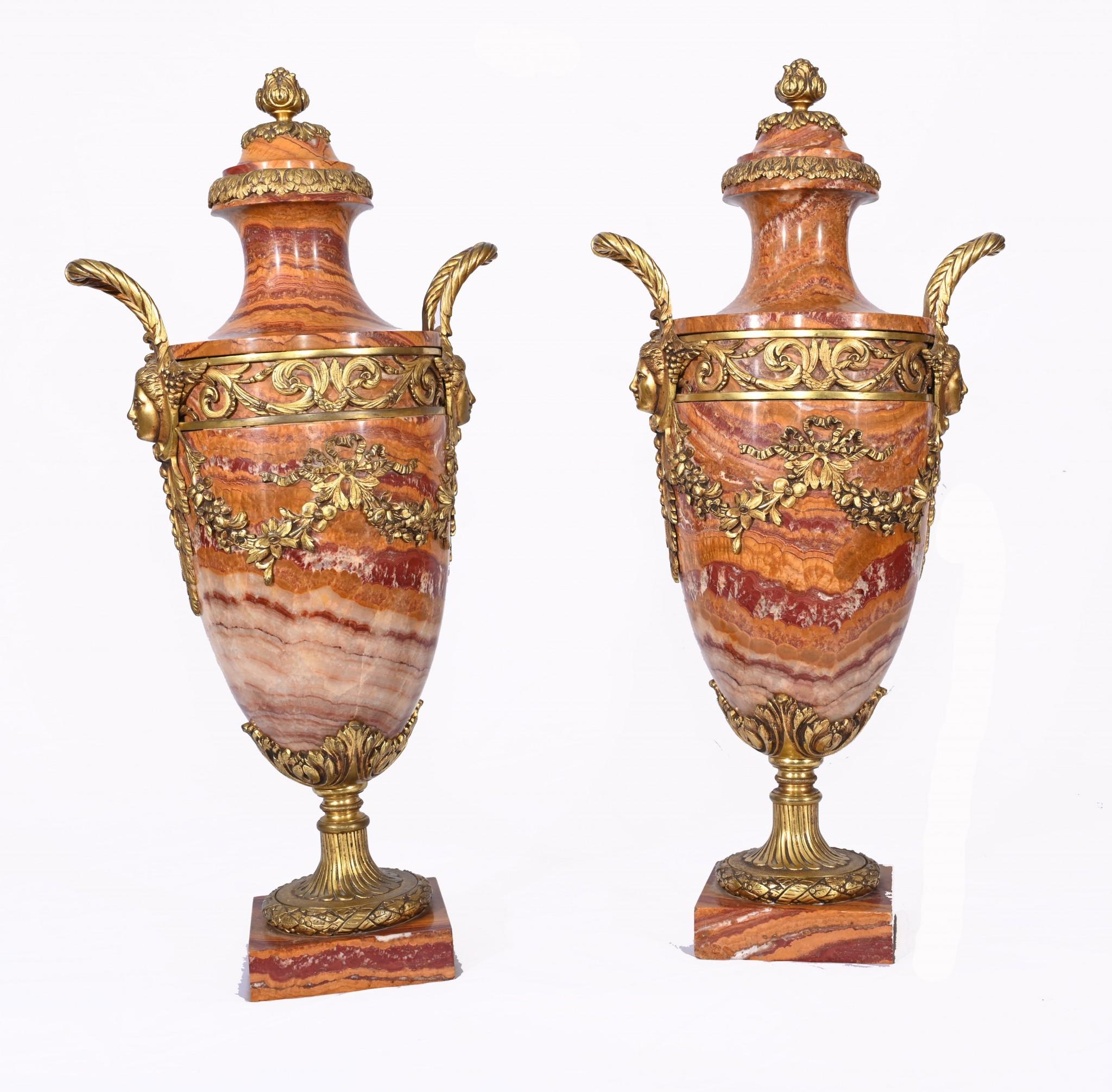 Gorgeous pair of French Empire marble cassoulets 
Classic urns of amphora form 
Beautiful tones of marble including salmon pink, orange, cream and burgundy
Ormolu fixtures are original and finely cast
Purchased from a dealer on Marche Biron at Paris