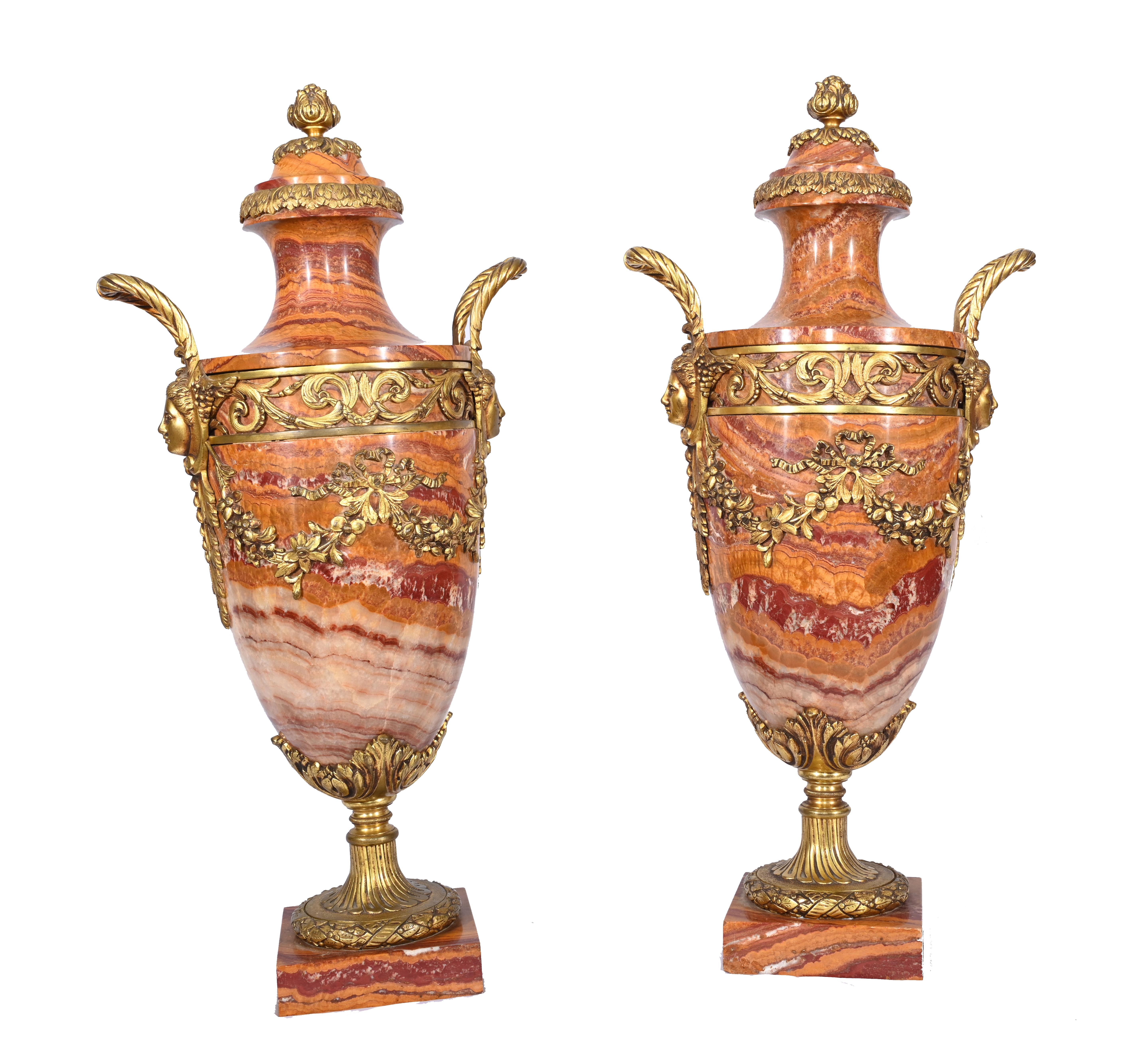 Gorgeous pair of French Empire marble cassoulets 
Classic urns of amphora form 
Beautiful tones of marble including salmon pink, orange, cream and burgundy
Ormolu fixtures are original and finely cast
Purchased from a dealer on Marche Biron at