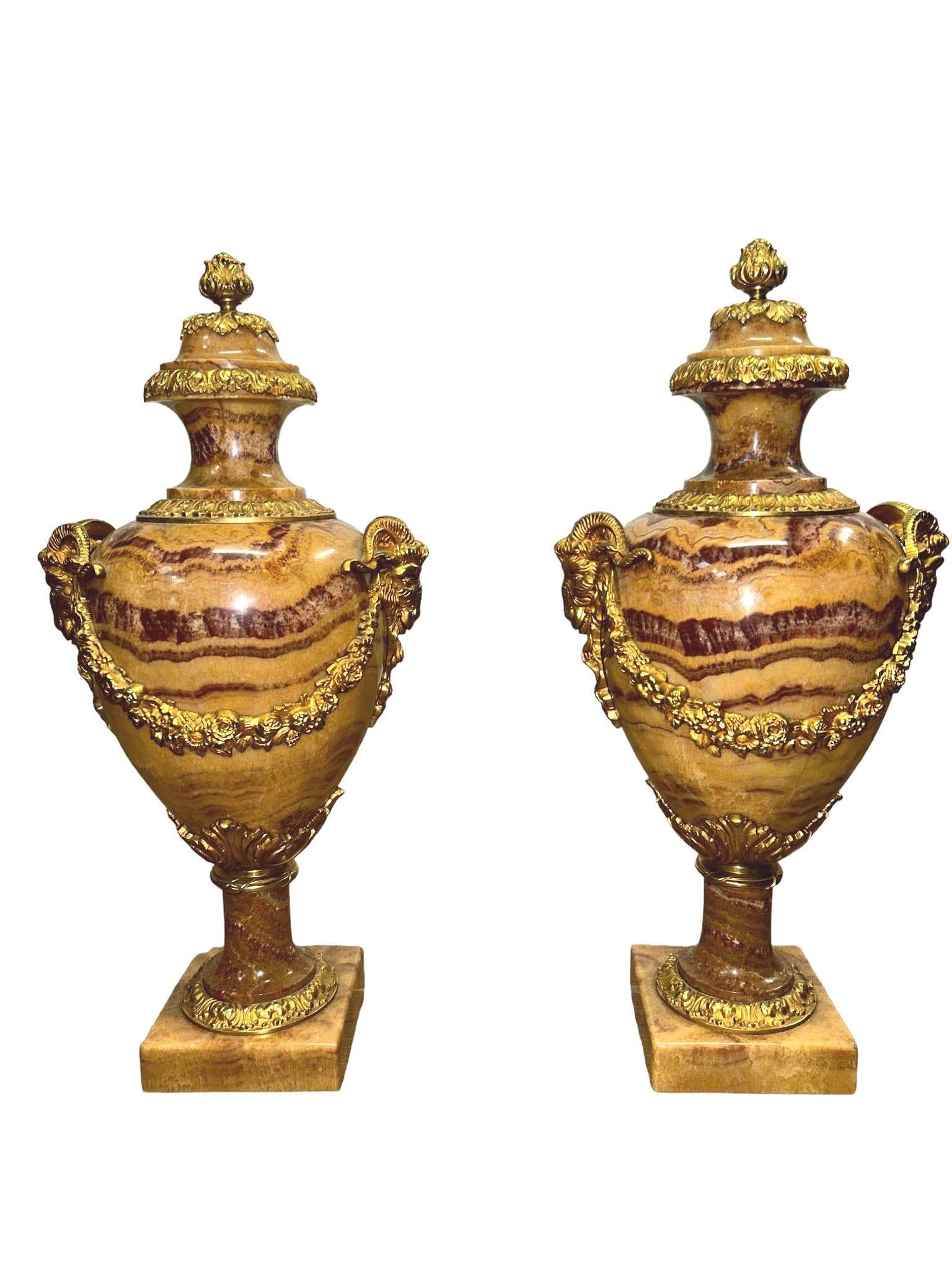 Classic pair of antique French cassolettes of amphora form These are solid marble so very heavy
Original gilt fixtures with rams head handles, encrusted floral sash, acanthus leaves and a pineapple finial
These would lift any interior
Bought from a