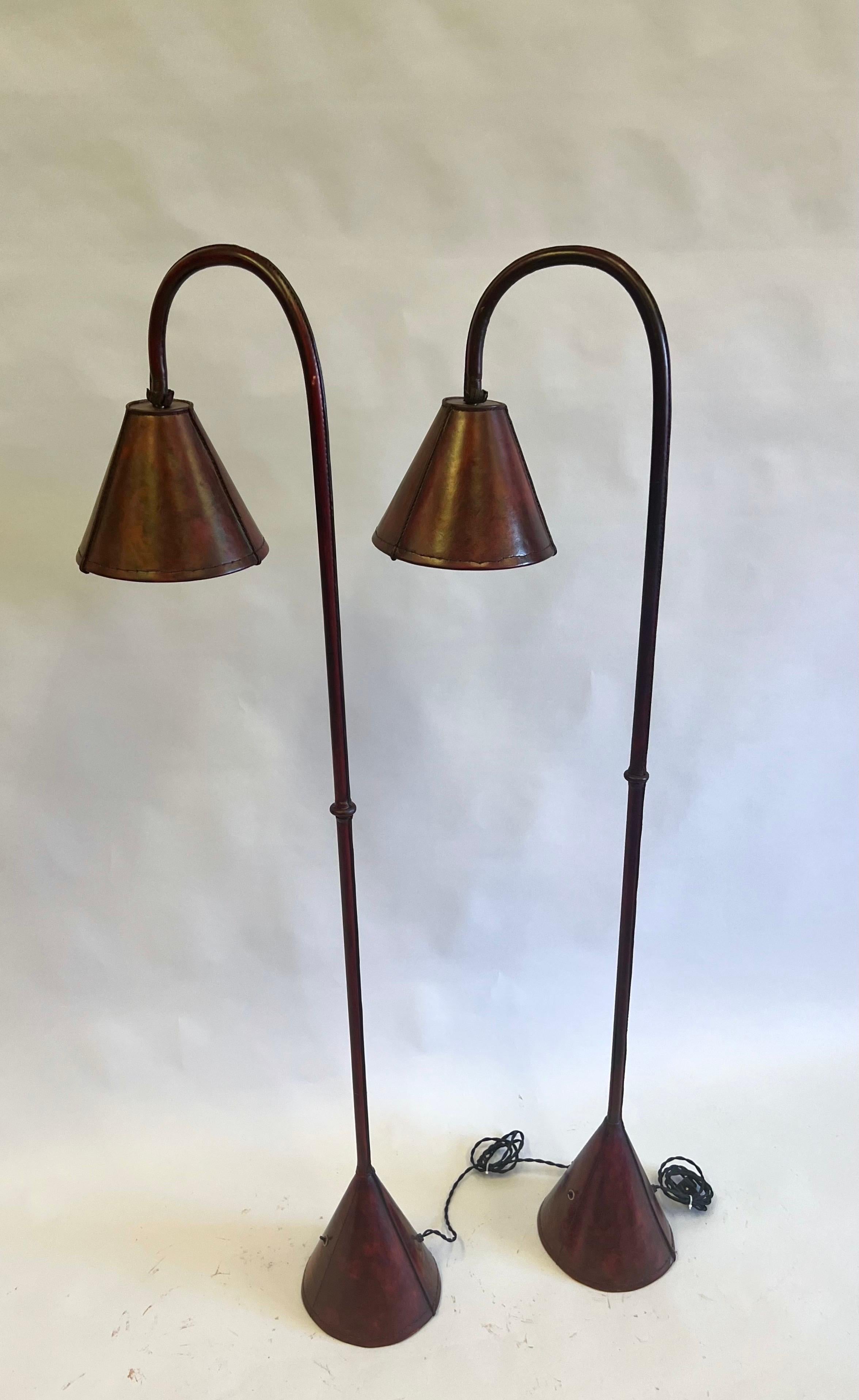 Hand-Crafted Pair, French Mid-Century Burgundy Stitched Leather Floor Lamps by Jacques Adnet For Sale
