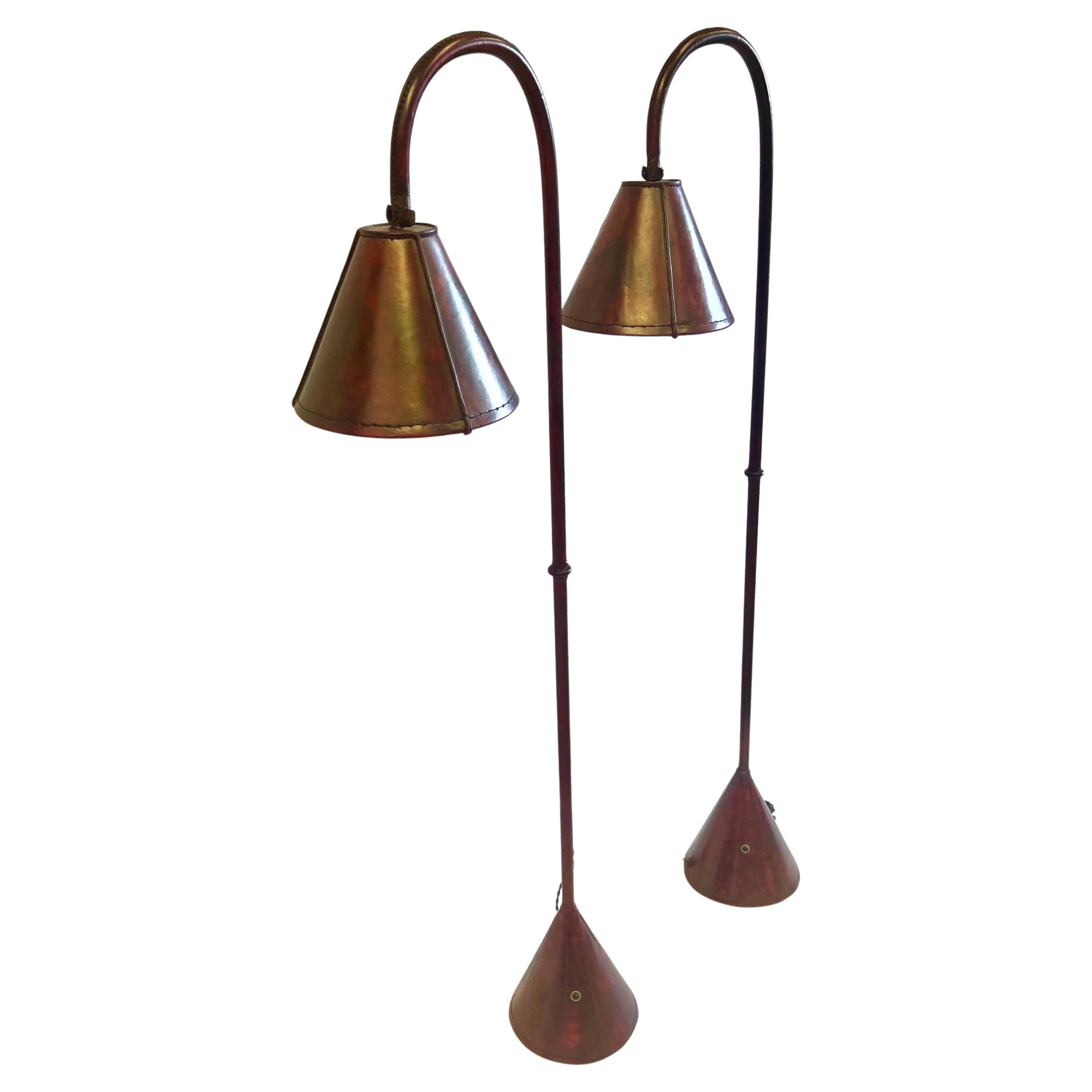 Pair, French Mid-Century Burgundy Stitched Leather Floor Lamps by Jacques Adnet For Sale