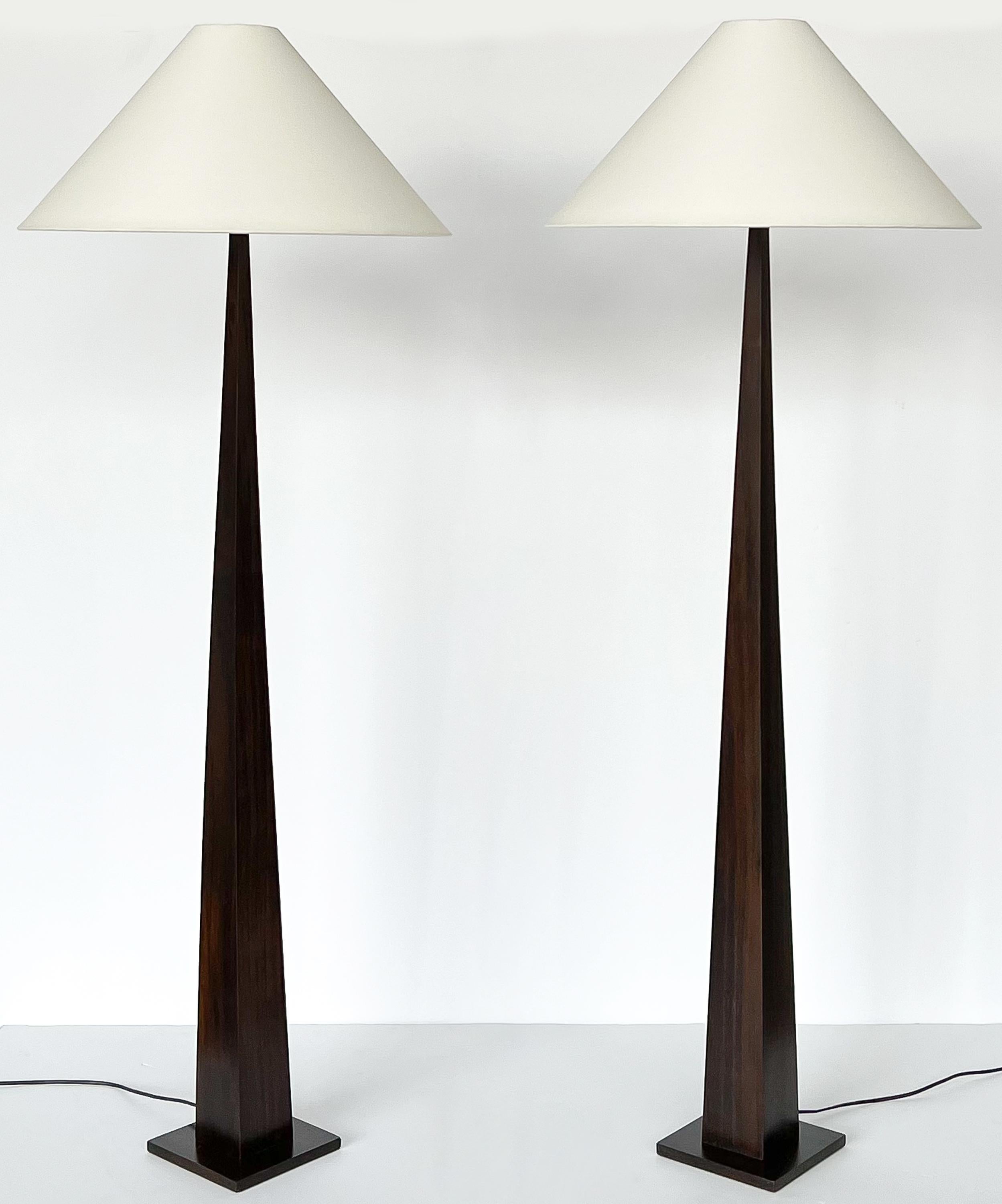 Pair of striking minimalist floor lamps by Luc Rabault for Atelier Lumens, France circa Late 20th Century. Dark stained solid wood stems tapper from 3.5