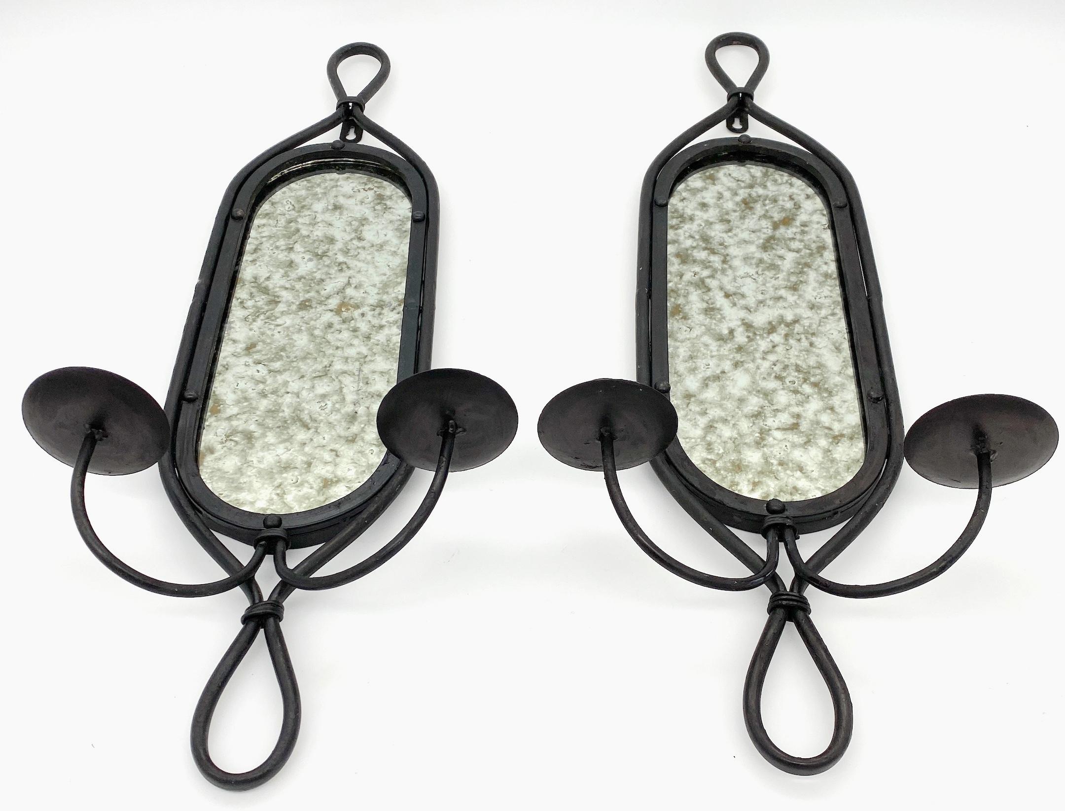 Pair French Modern Blackened Wrought Iron Distressed Mirror 2 Light Candle Sconces
France, 20th Century 

A pair of French Modern Blackened Wrought Iron Distressed Mirror 2-Light Candle Sconces, originating from  the 20th-century France. Each sconce