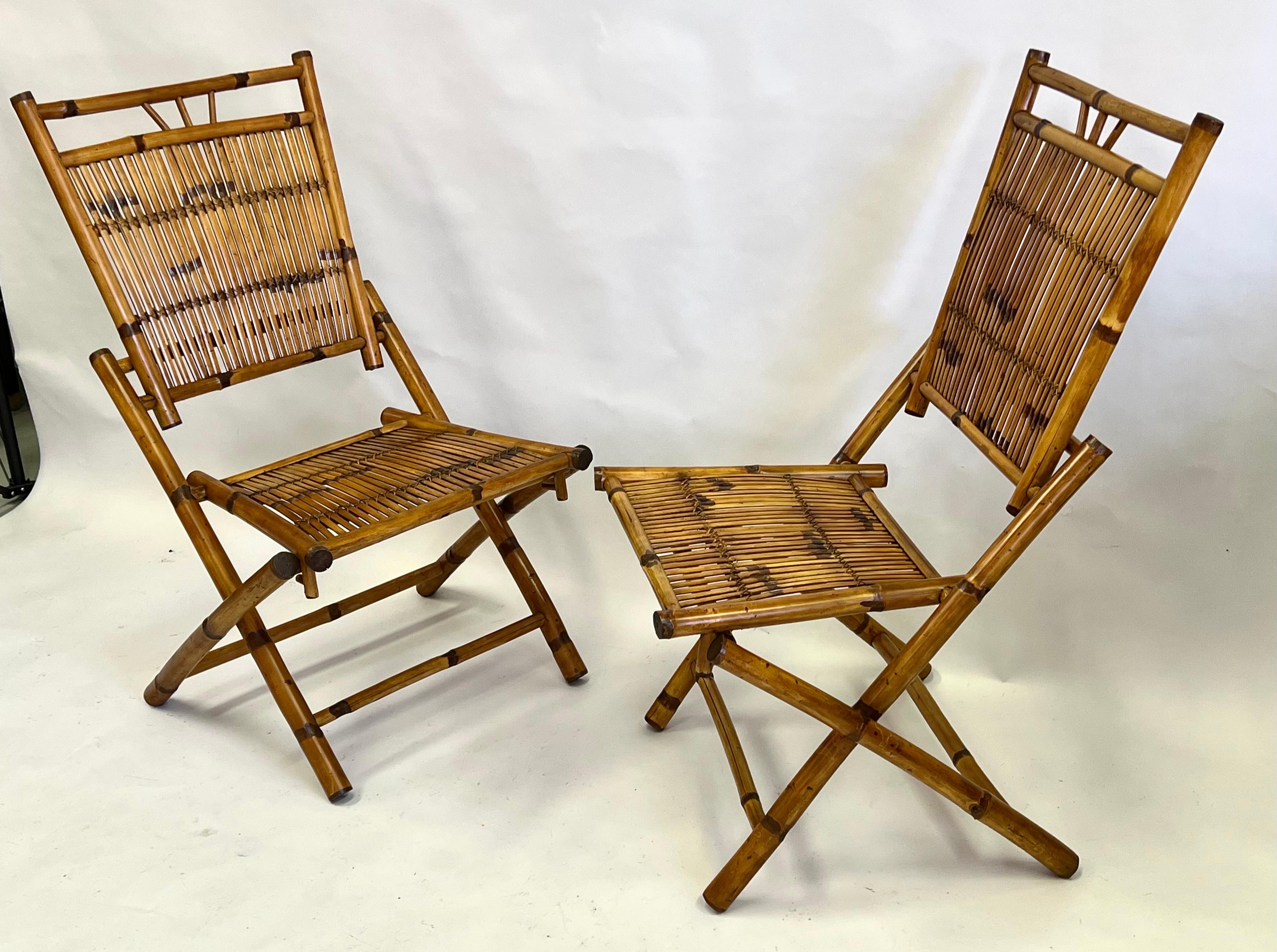A Rare and Elegant pair of French Mid-Century Modern Neoclassical Rattan and bamboo side chairs or lounge chairs. The chairs unite sober neoclassical sensibilities with a modern look. The pieces have a classic X-form leg structure and are