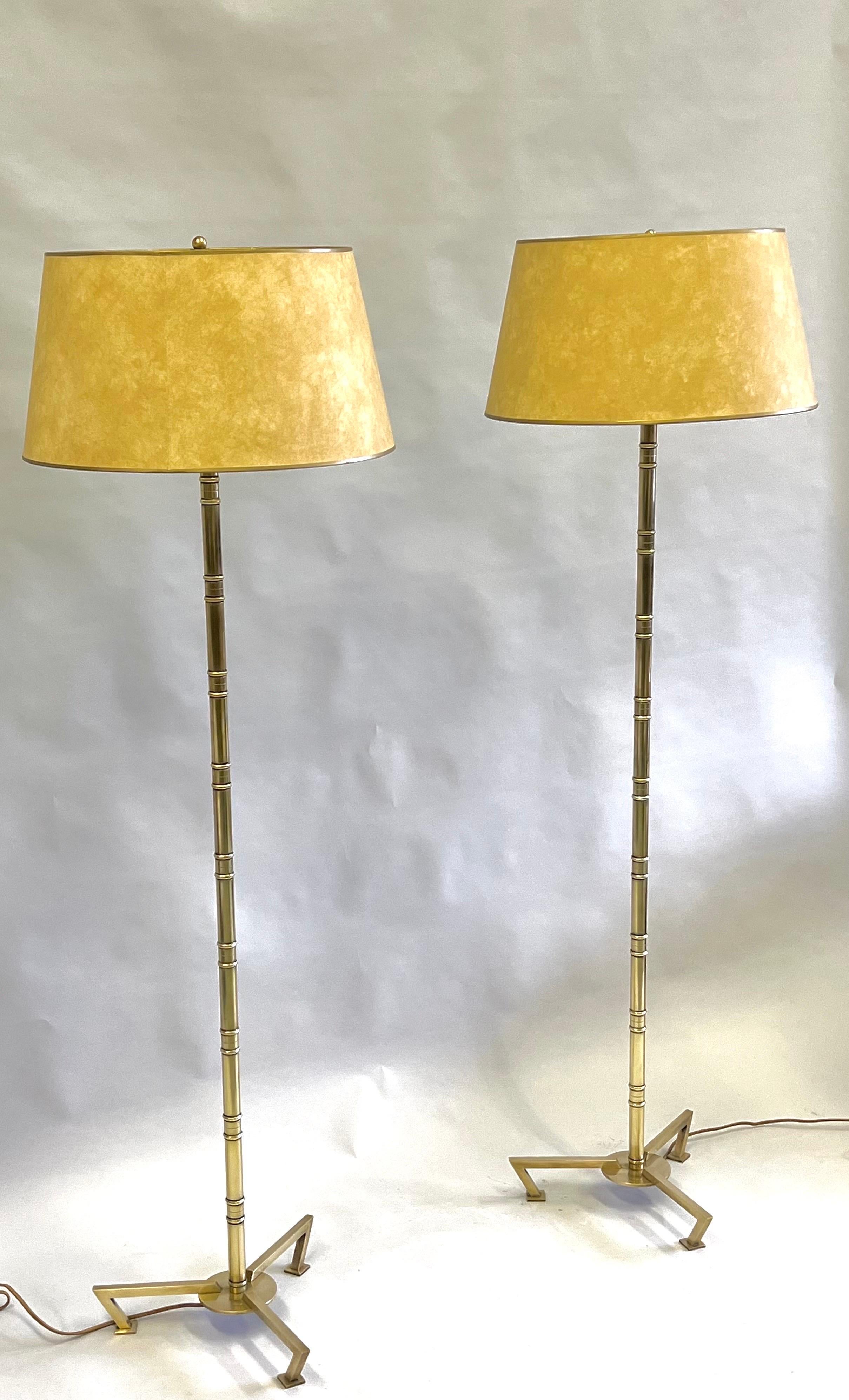 Rare, Elegant and Timeless Pair of French Mid-Century Modern Neoclassical Faux Bamboo Floor Lamps in solid brass by Maison Bagues, Paris. The brass is the highest quality and the patina is natural and derived over time. The form is exquisite using a