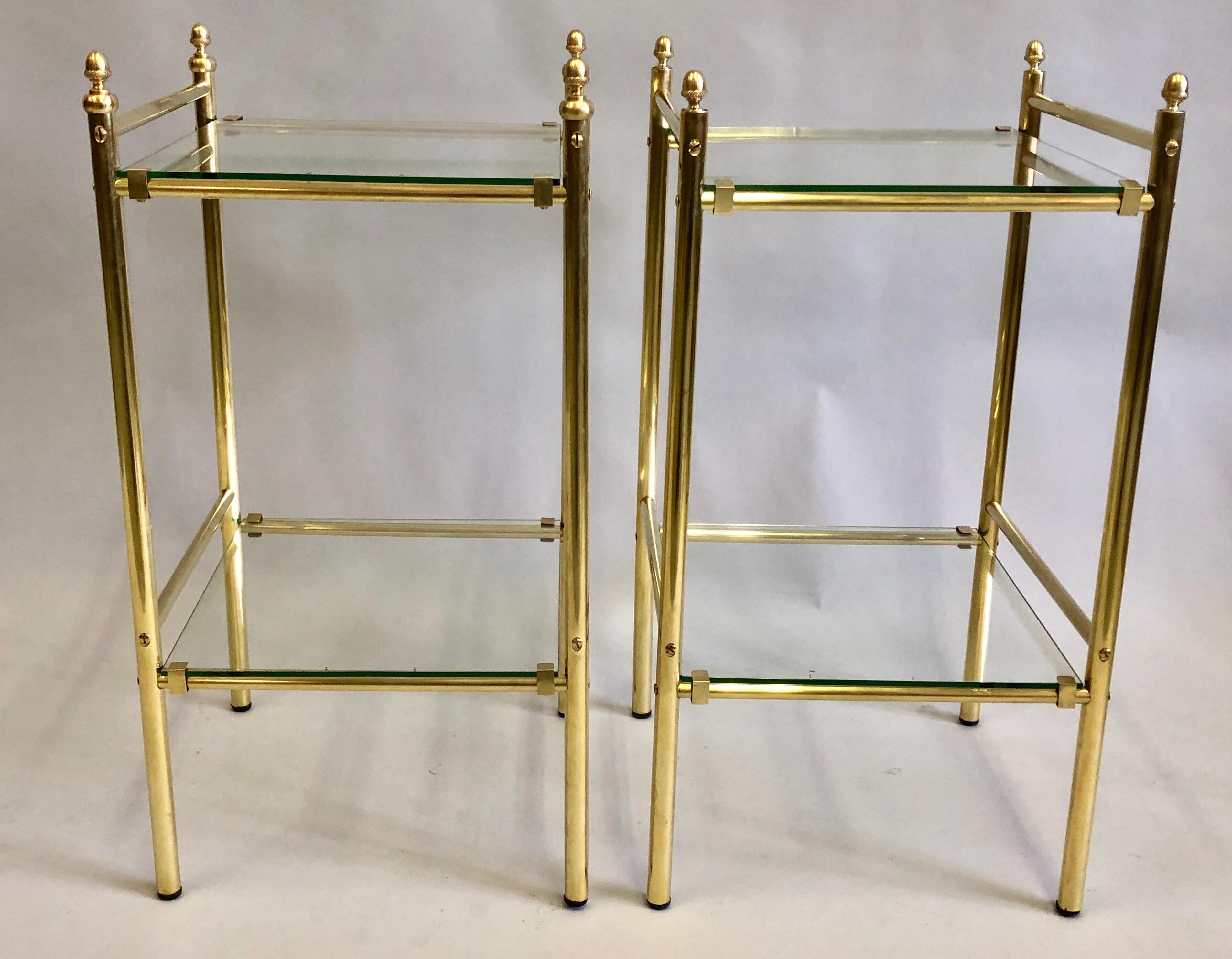 Pair of French Mid-Century Modern neoclassical double level brass side tables / nightstands with original green tint glass tops by Maison Jansen.

These Jansen double tier end tables feature solid brass clips which secure the glass in place and