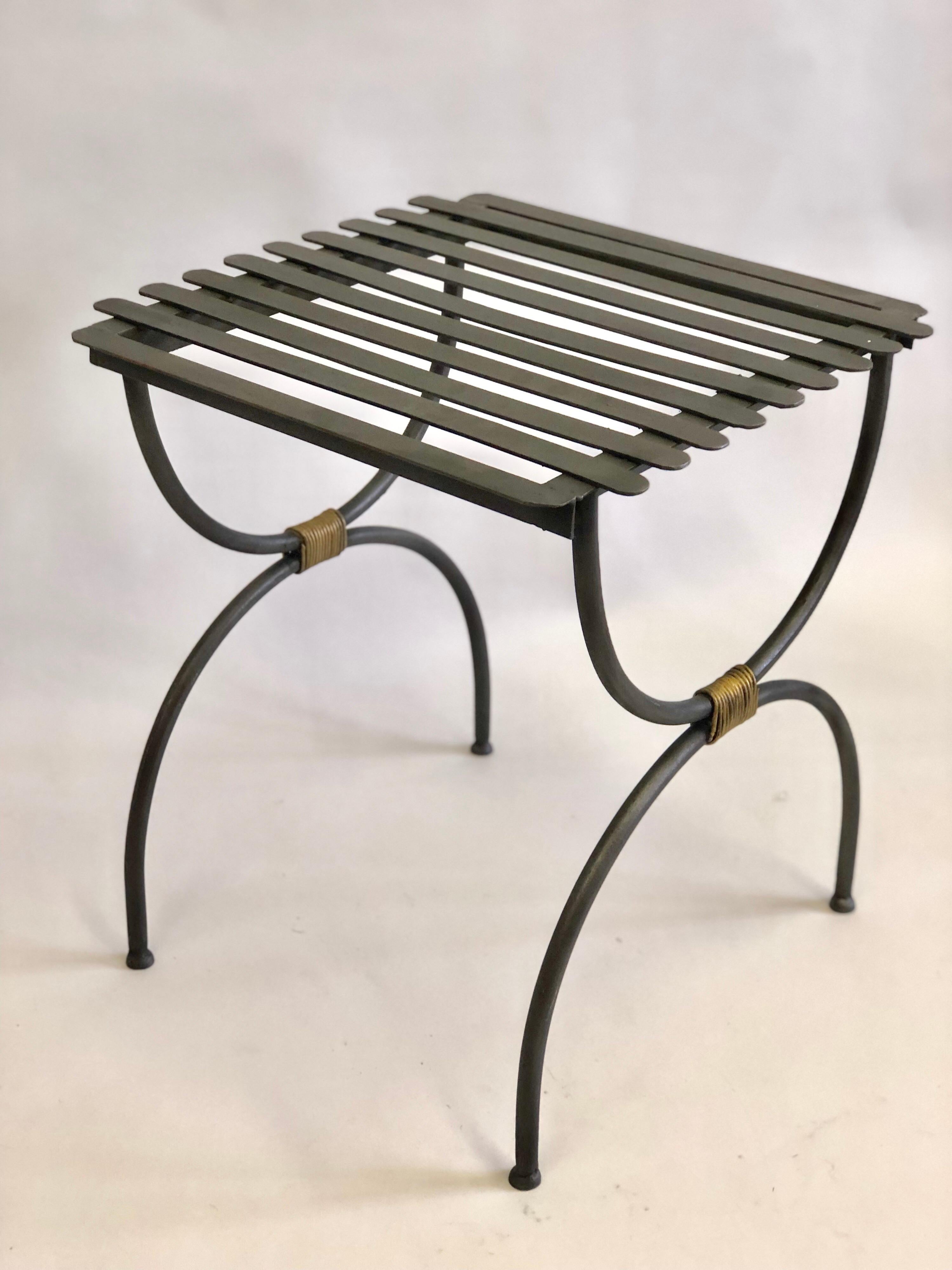 2 Pairs of French X-form iron side tables / luggage racks from the Mid-Century Modern period . The pieces, in matte black patina, are in a sober, pure, curile form (X-Form) with gilt iron wrappings uniting upper and lower halves. The convenient size