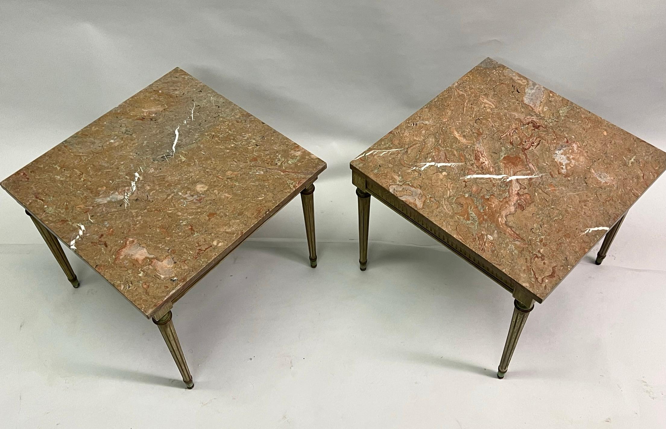 Elegant pair of French Mid-Century Modern neoclassical end or side tables in the Louis XVI style and are attributed to Maison Jansen. The pieces are composed of hand carved and hand painted wood frames and have complimentarily toned original marble