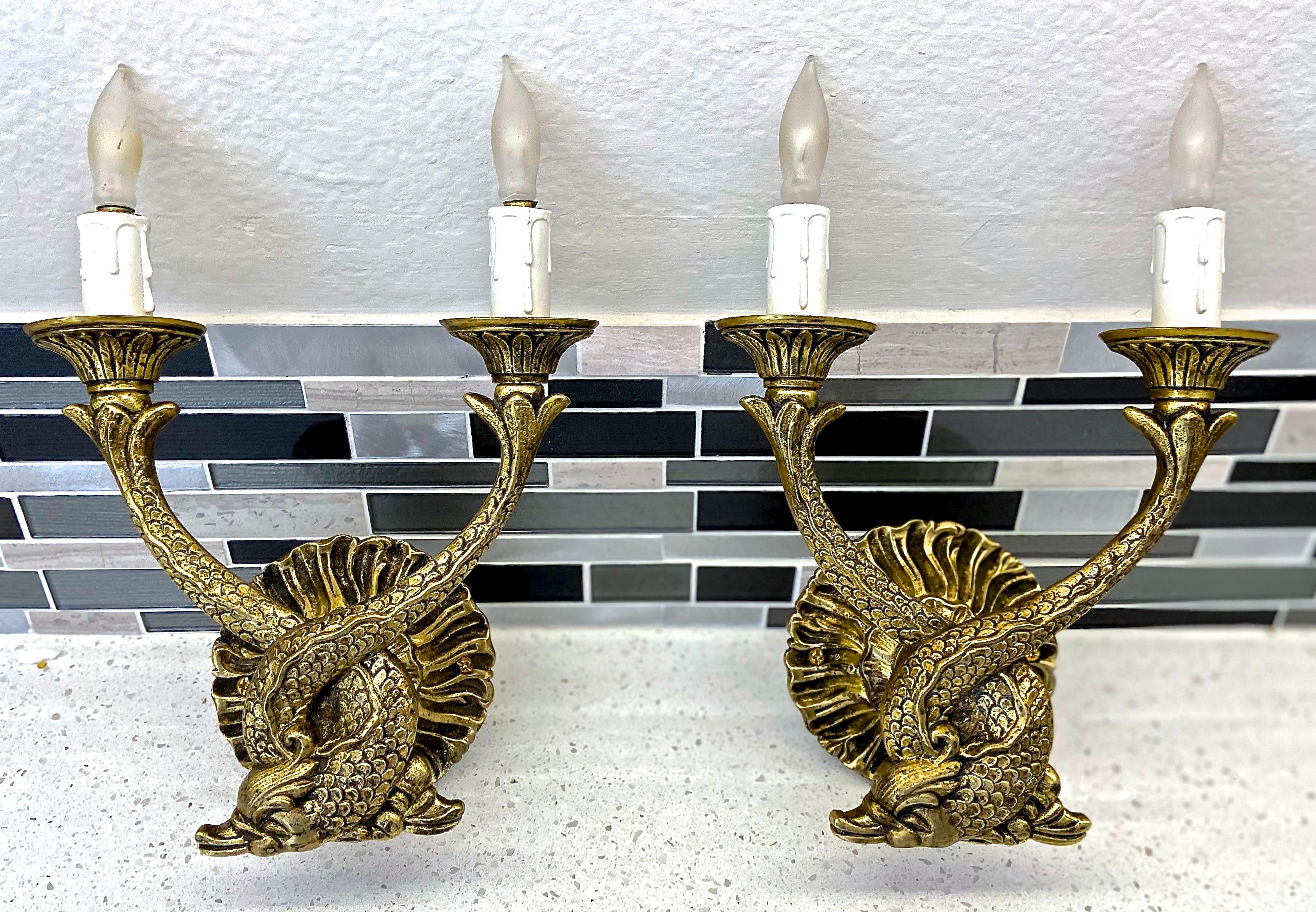 Pair of two light French neoclassic style brass wall sconces with dolphin motif. Newly wired. 
Dimensions: 10.5