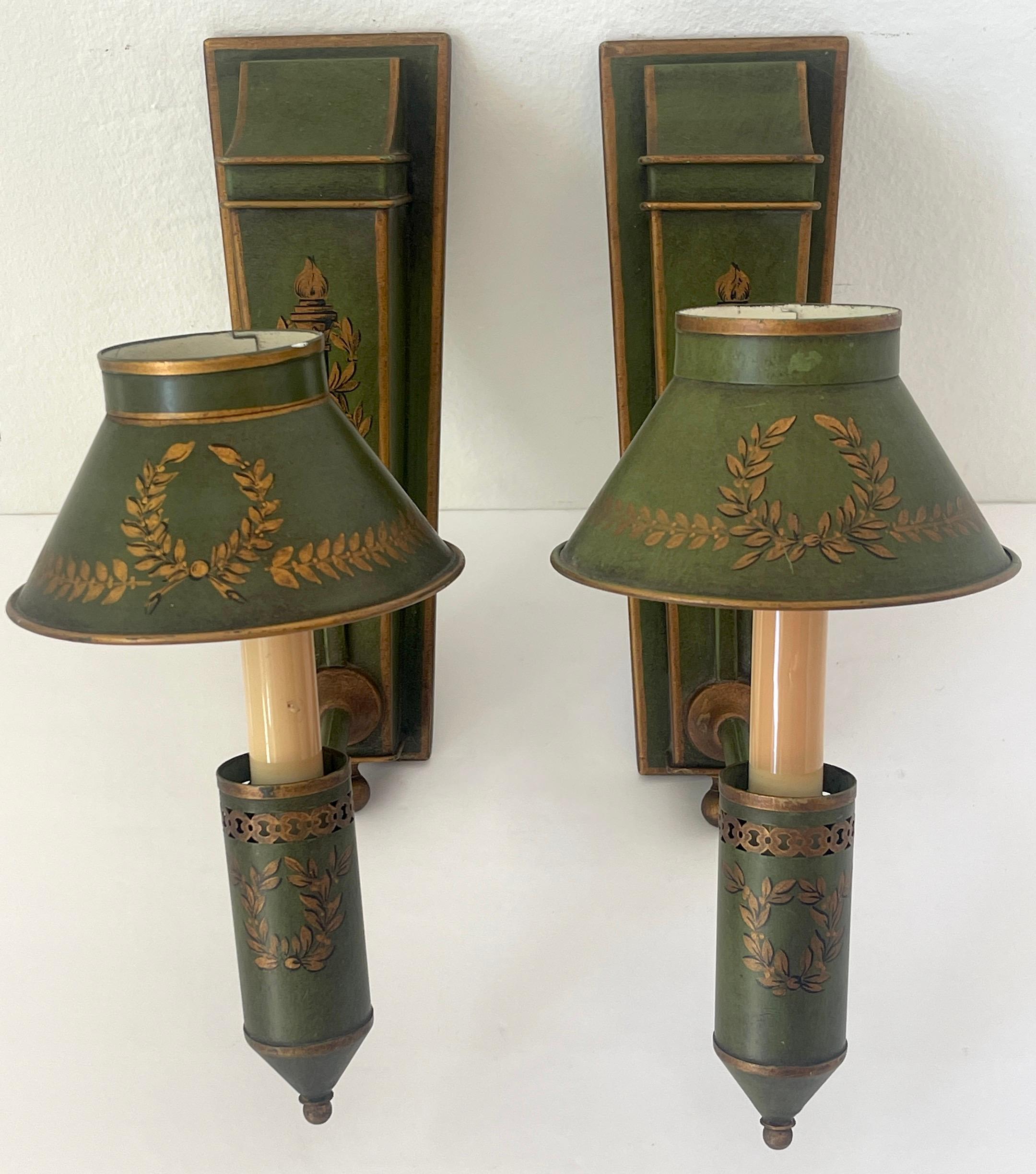 Pair French Neoclassical Olive Green Tole & Gilt Sconces with Shades. 

France, Circa 1950s

This exquisite pair of French Neoclassical olive green tole and gilt sconces, dating to circa the 1950s, embodies timeless elegance and sophistication. Each