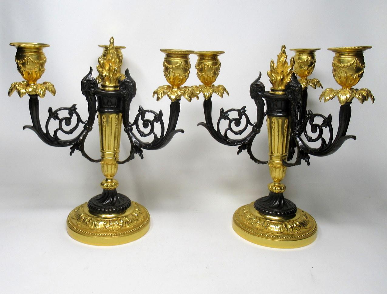 An exceptionally fine quality pair of French gilt & patinated bronze three-arm candelabra of generous proportions and good heavy gauge, made during the first half of the 19th century. 

The finely chased sconces issuing from three scrolling arms