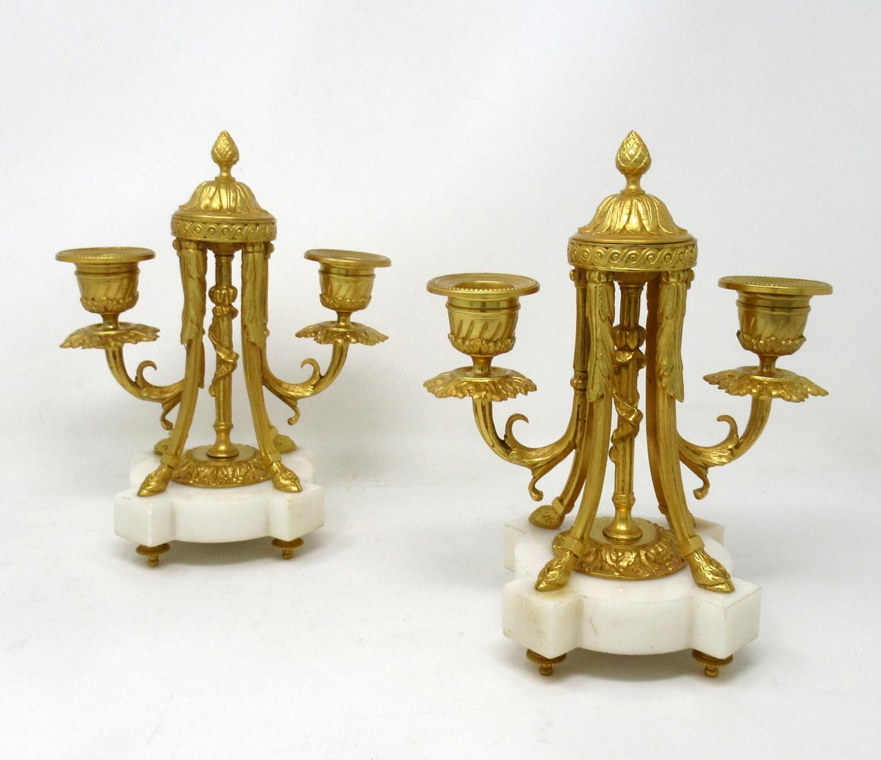 An exceptionally fine quality pair of French gilt bronze and statutory cream marble twin arm candelabra of medium proportions, made during the third quarter of the 19th century. 

The finely chased candle sconces issuing from scrolling arms