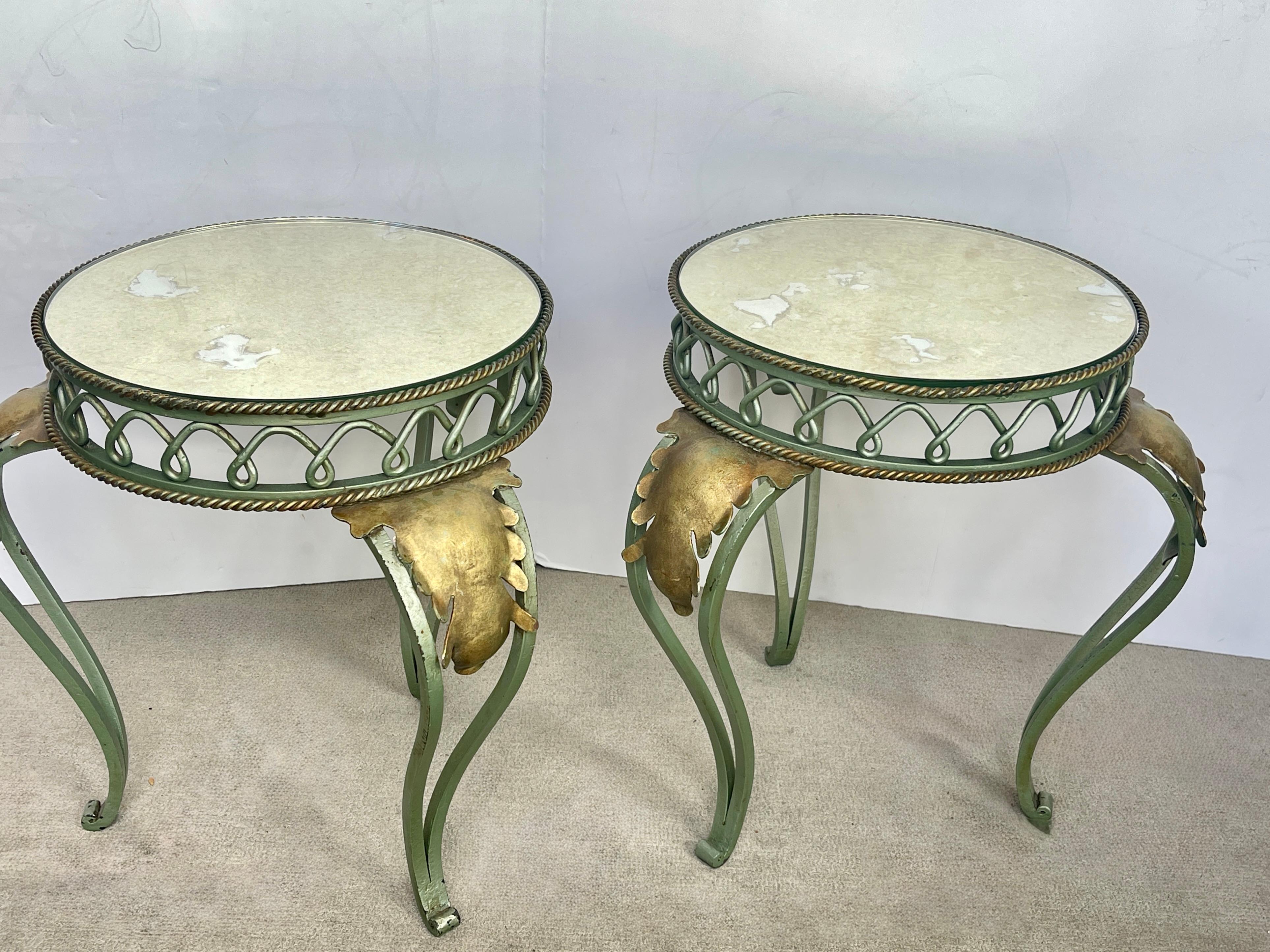 This is a great looking Pair French painted and Gilt Wrought Iron with antiqued mirrored tops, Martini tables or side tables, 1940s
They are in the style of Rene Prou. 
Good overall condition, minor finish loss to the green paint around the legs
The