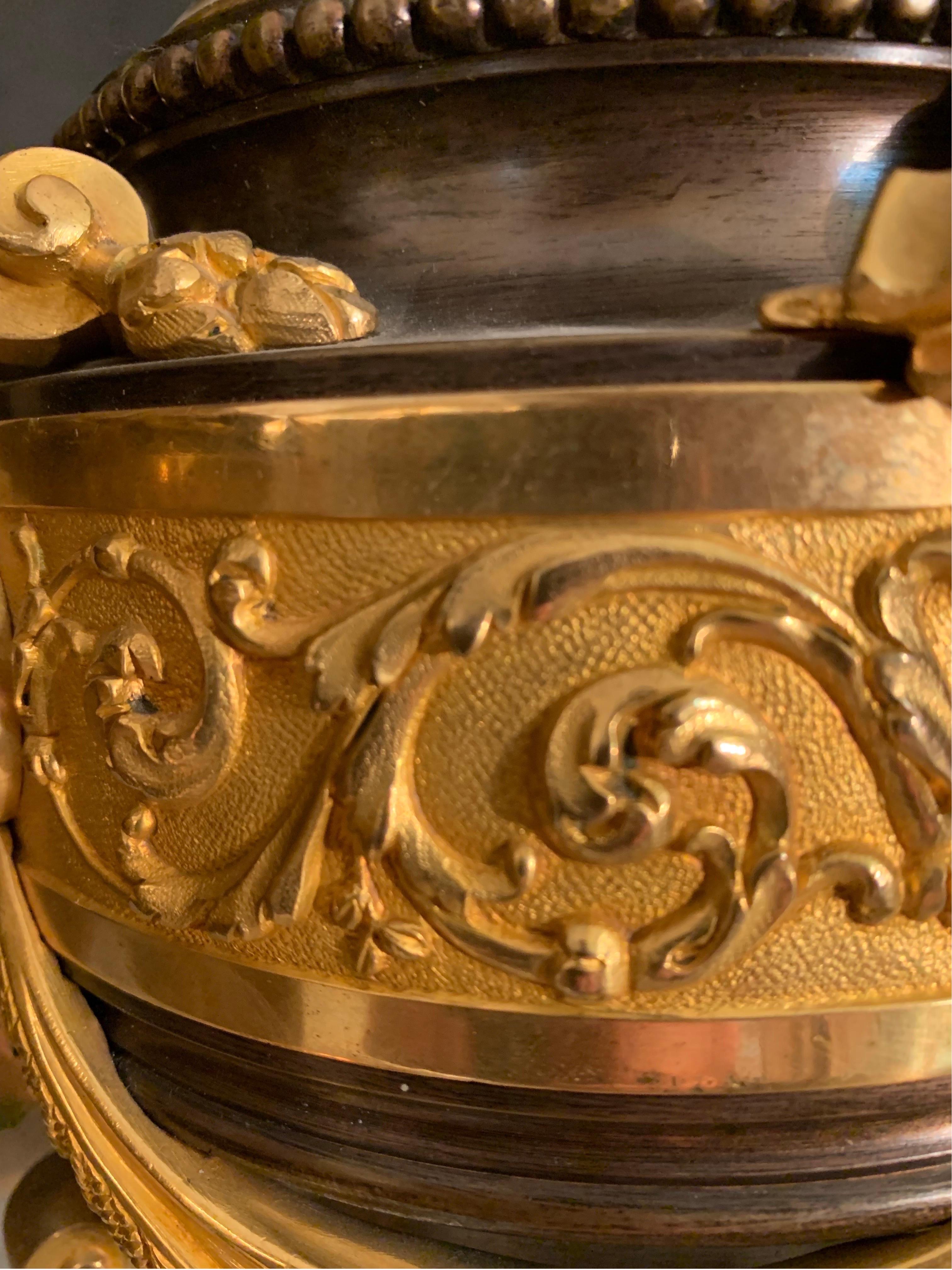 Paire de vases / lampes à deux anses en bronze et bronze doré de style Napoléon III, de très bonne qualité, chacun avec un décor végétal en bronze, les ornements en bronze doré avec des boucliers et des motifs de draperies suspendues. Les anses sont