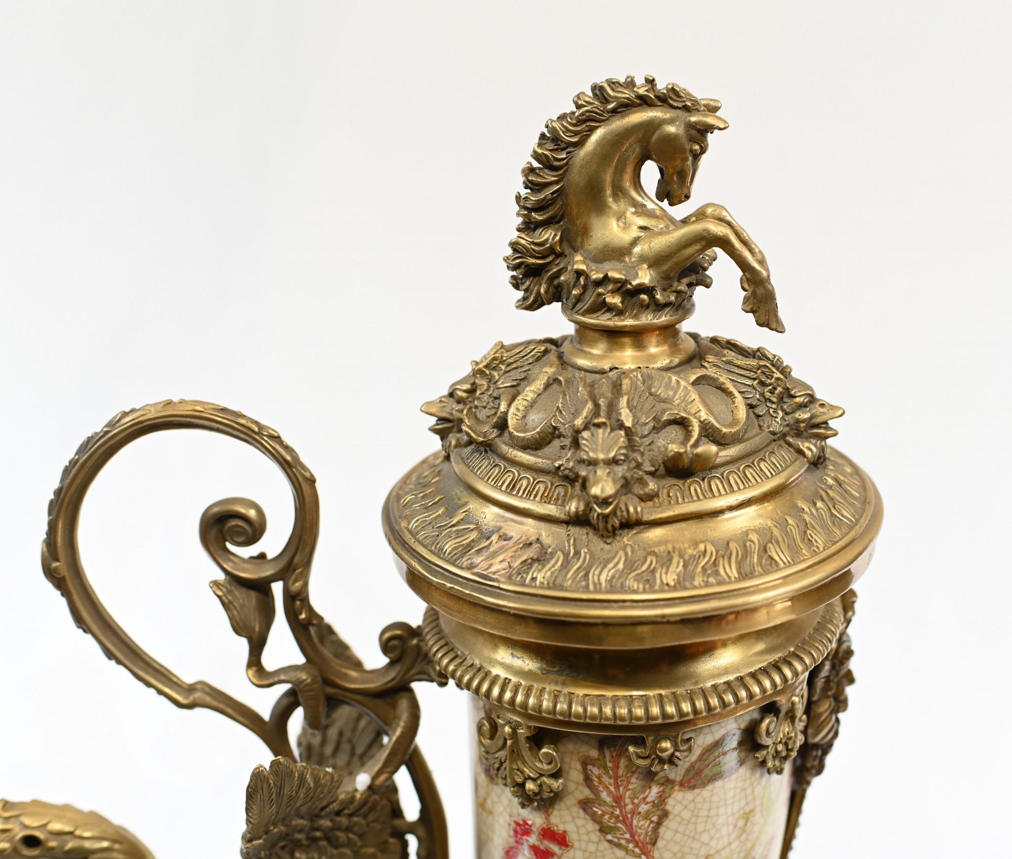 Stunning pair of French porcelain cornucopia lidded vases
Also referred to as horn of plenty, this amazing pair will be the central focus of any room
Main body of horn is in porcelain with antiqued finish and hand painted designs
Ormolu fixtures