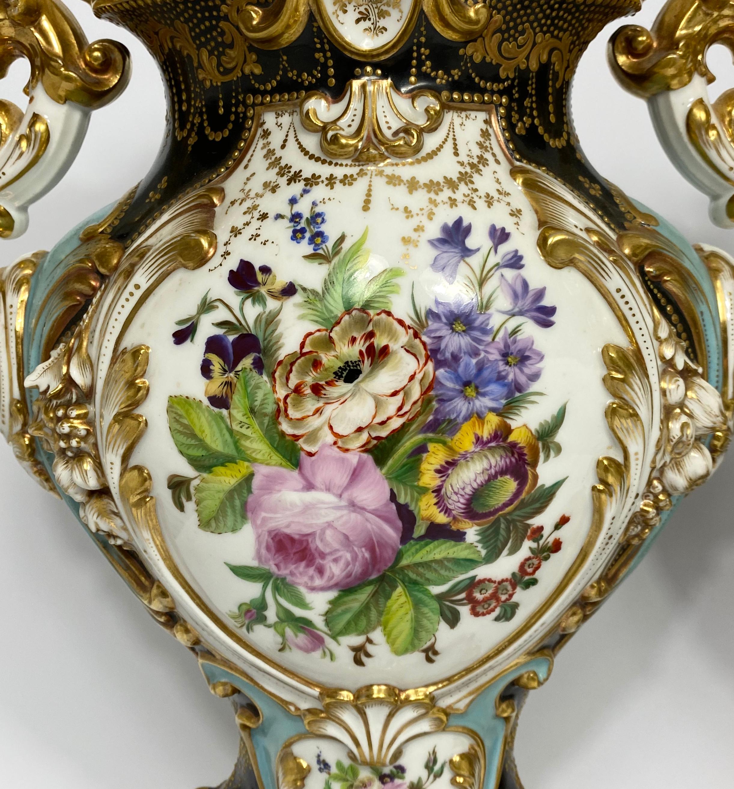 Pair of Paris porcelain vases, probably Jacob Petit, circa 1840. The elaborately modelled vases, having rococo scroll and flower moulded panels, finely painted with Summer flowers. All upon a black and turquoise ground, decorated with raised gilt