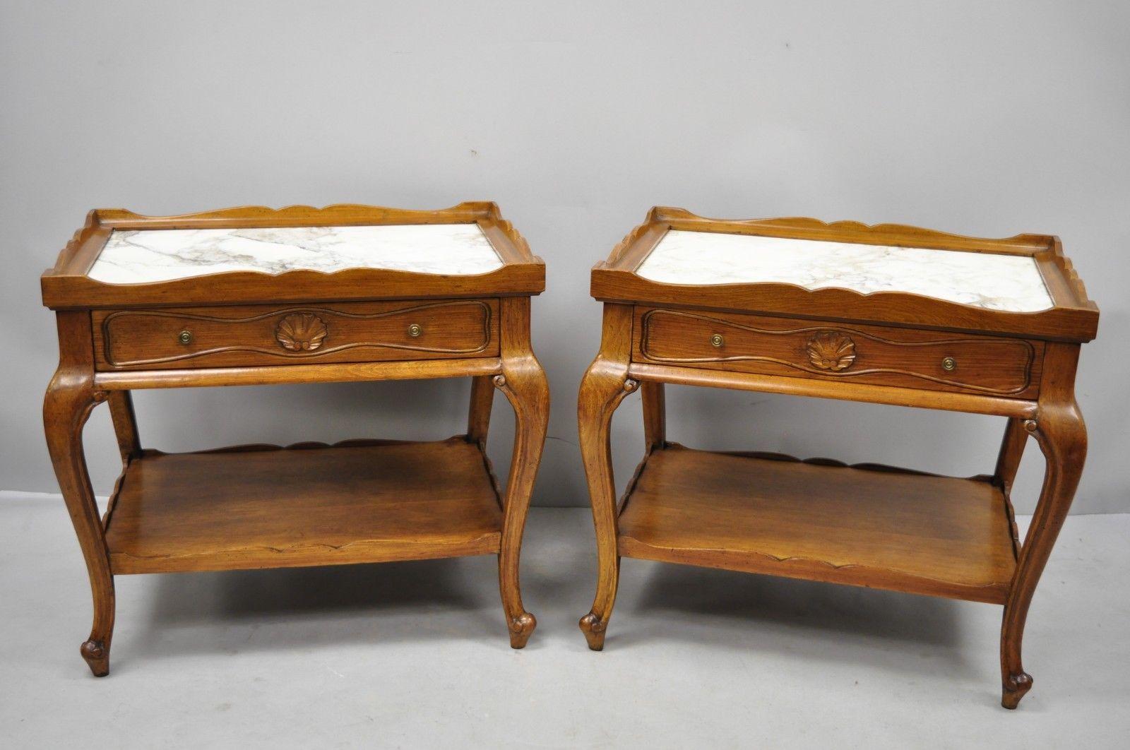 Pair of French Provincial Louis XV style marble top shell carved end tables Danby. Items feature carved shells on all sides, inset marble top, lower shelf, beautiful wood grain, original Danby stamp, 1 dovetailed drawer, cabriole legs, quality