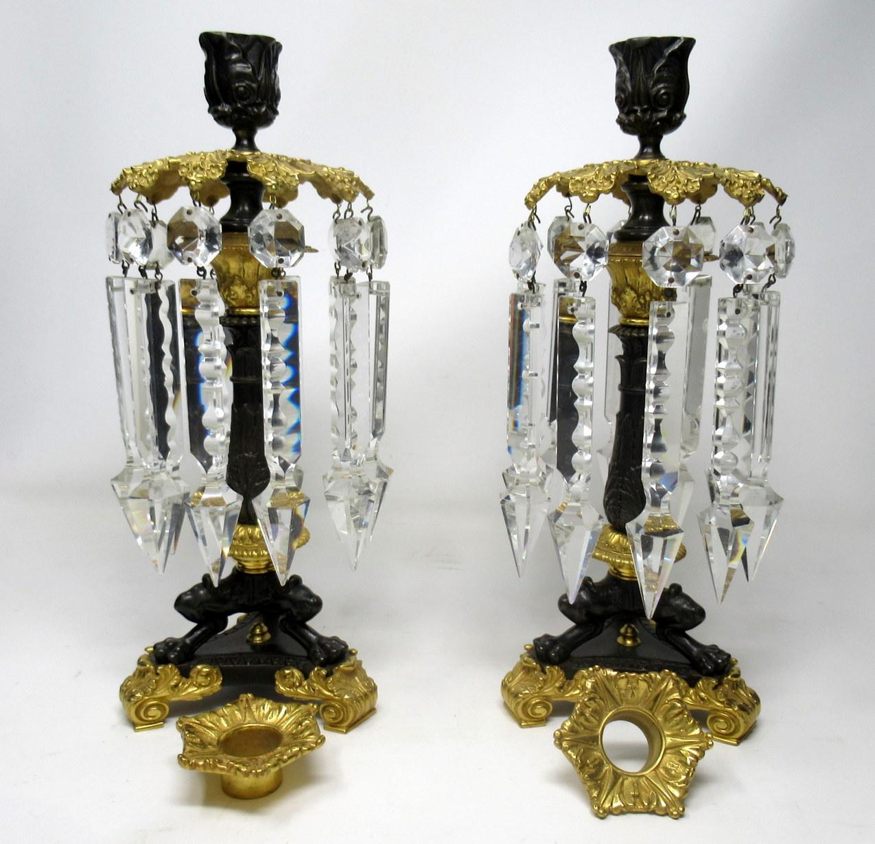 A very substantial and large pair of continental, possibly French cut crystal, ormolu and bronze single light heavy gauge candlesticks - lusters, first half of the 19th century. 

Each with an Acanthus Leaf ormolu canopy with ten hand facet-cut