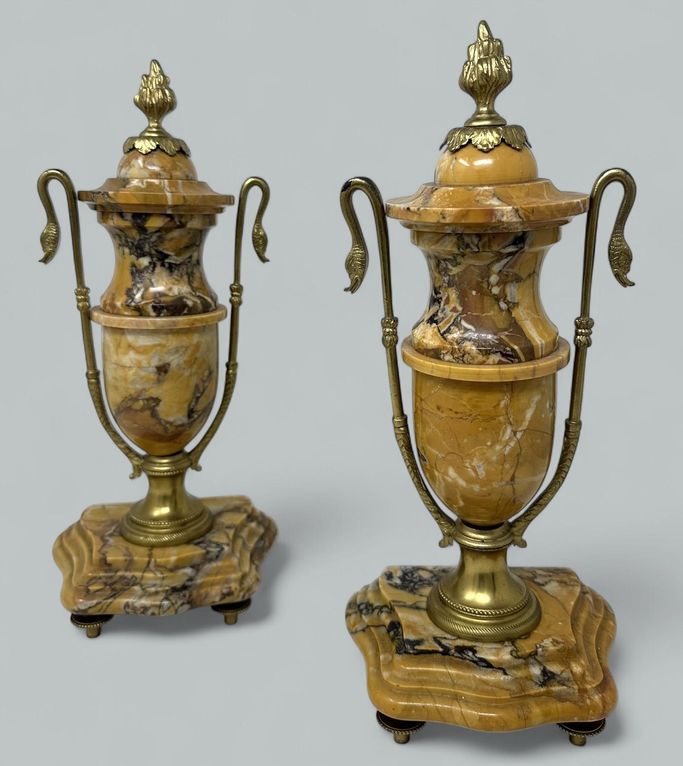 Stunning Pair French Well Veined Sienna Marble and Ormolu Twin Handle Urns of exceptional quality, in the Regency style, last half of the Nineteenth Century of medium proportions.  

Each of ovoid outline with applied nicely cast ormolu mounts and