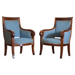 Pair of French Restauration Period Walnut and Upholstered Bergeres, circa 1825