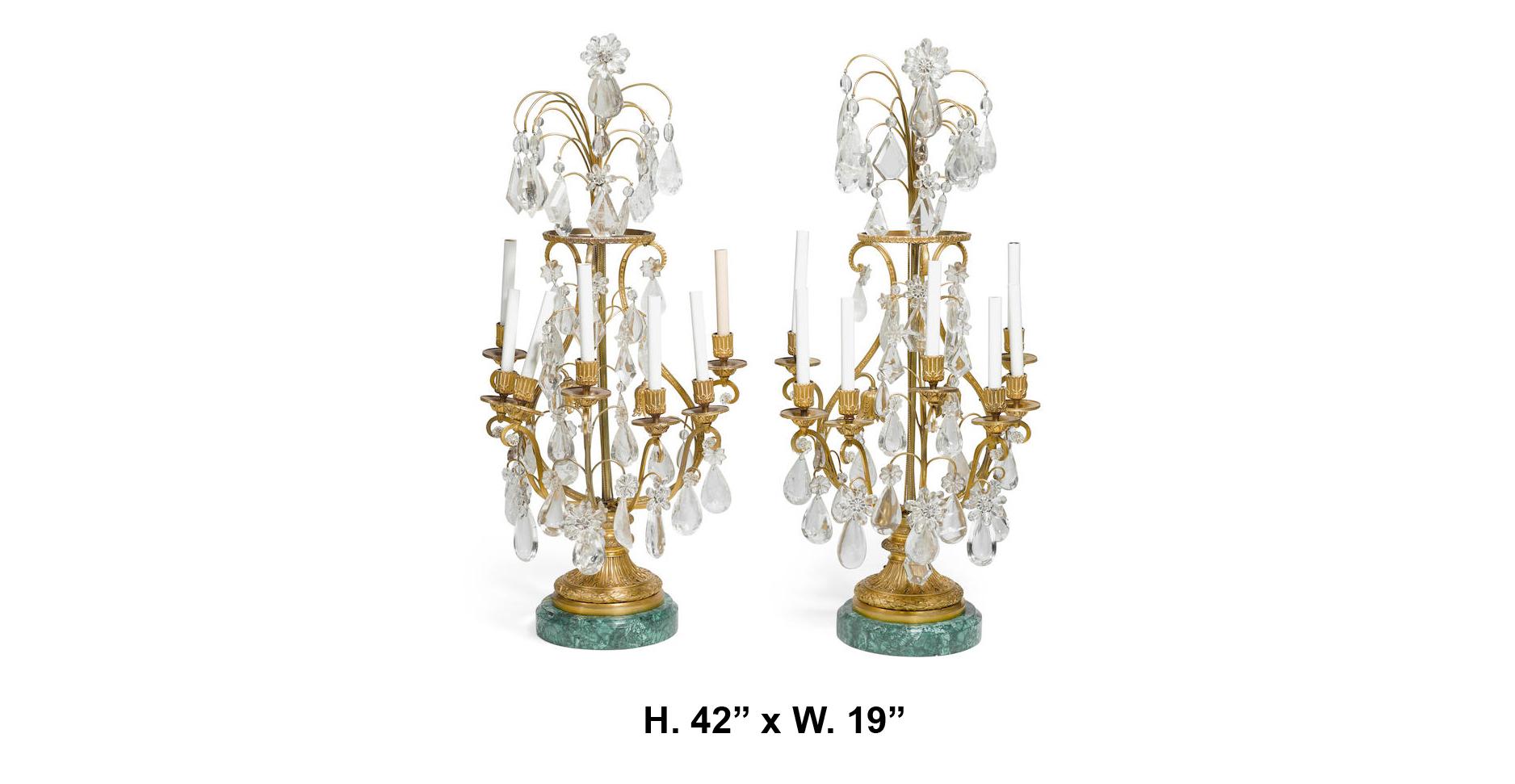 Spectacular and massive pair of 19th century French Louis XVI style rock crystal and fine quality ormolu-mounted nine-light girandoles with malachite veneered round bases. The rock crystal prisms used are top-tier quality, each piece is handcut and