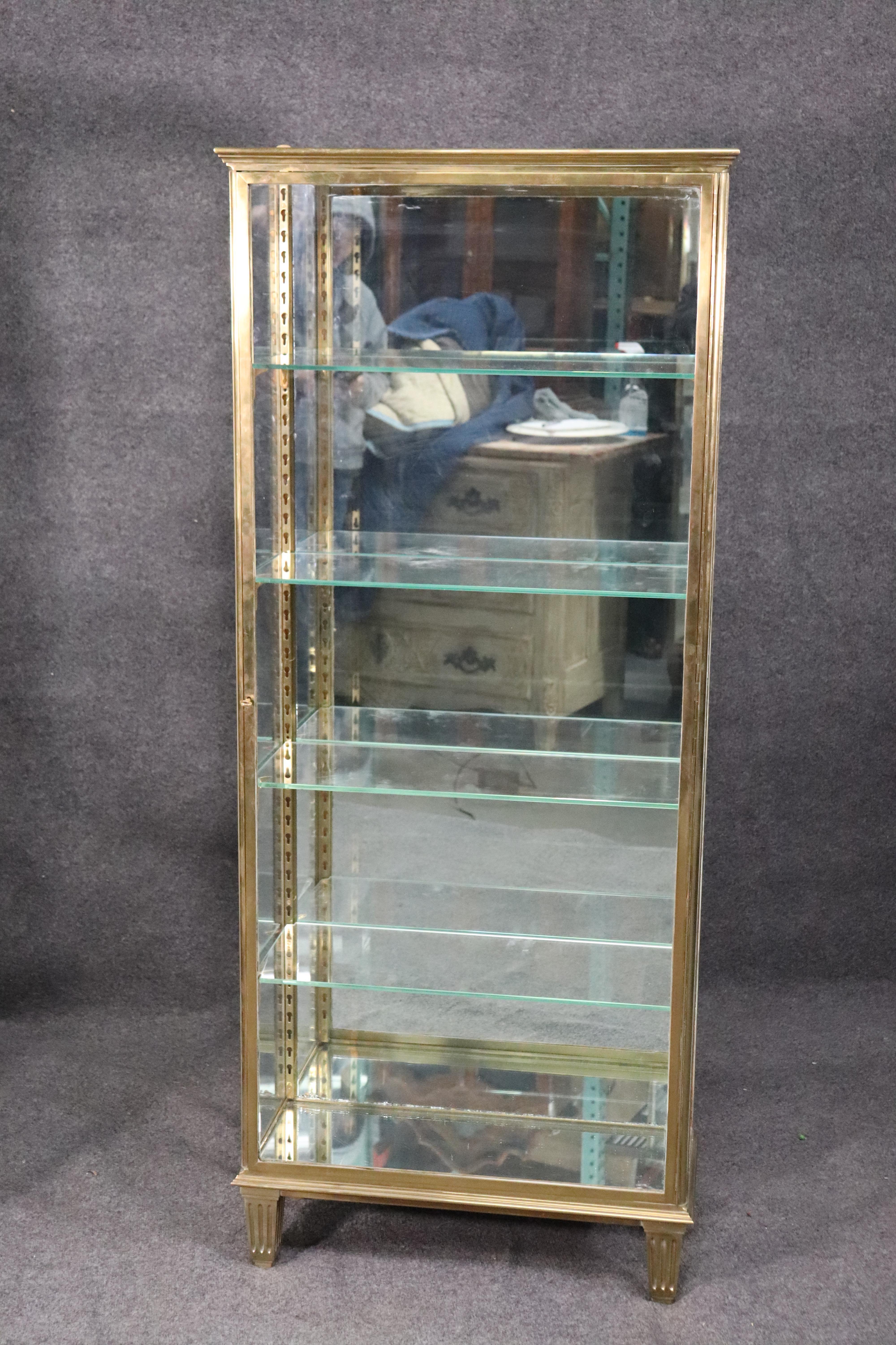 This is a very, very rare pair of French solid brass not tubular hollow brass, vitrines. The vitrines are in superb antique condition and have solid, hearty construction and build quality. They each have removable and adjustable shelves and have