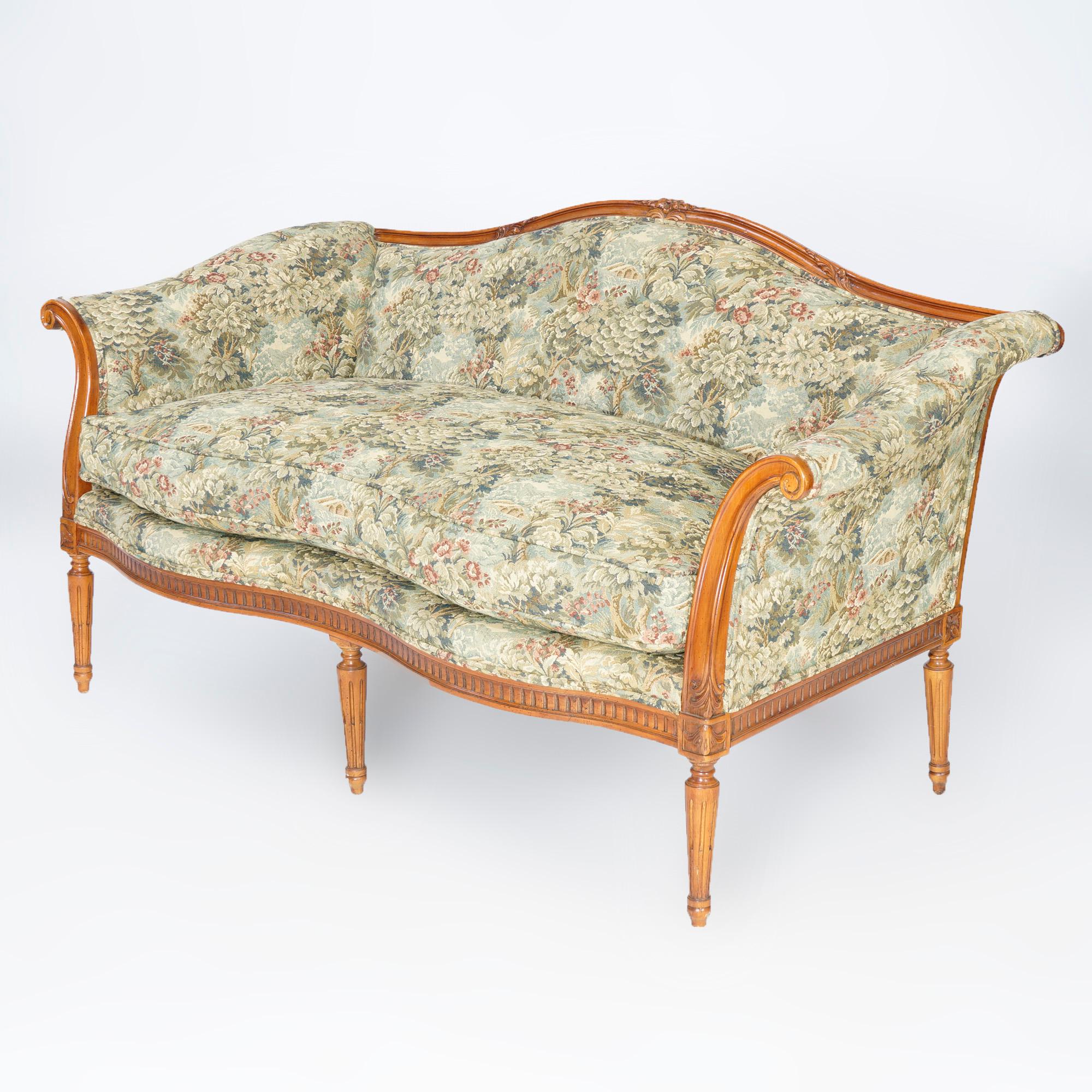 A matching pair of French style floral upholstered settees by John Widdicomb Furniture Company offer serpentine form with scroll form arms, raised on turned, reeded and tapered legs, maker label as photographed, 20th C

Measures- 33''H x 64''W x
