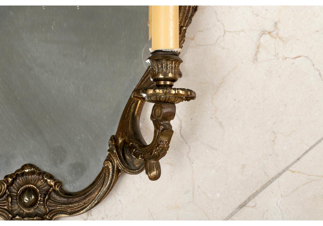 Quality brass baroque style cartouche shaped mirrors with leafy surrounds. With twin scrolled lights with faux candle paper sleeves. 
H. 19