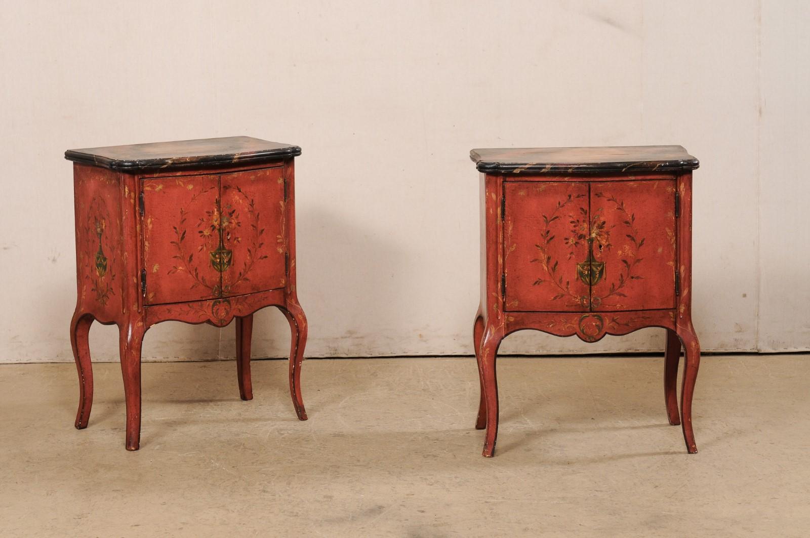 A pair of French-style raised side chests with decoratively painted wood finish and shapely bodies. This vintage pair of commodes from America, have been designed with French influences and feature gently bowed bodies with scalloped top corners, and