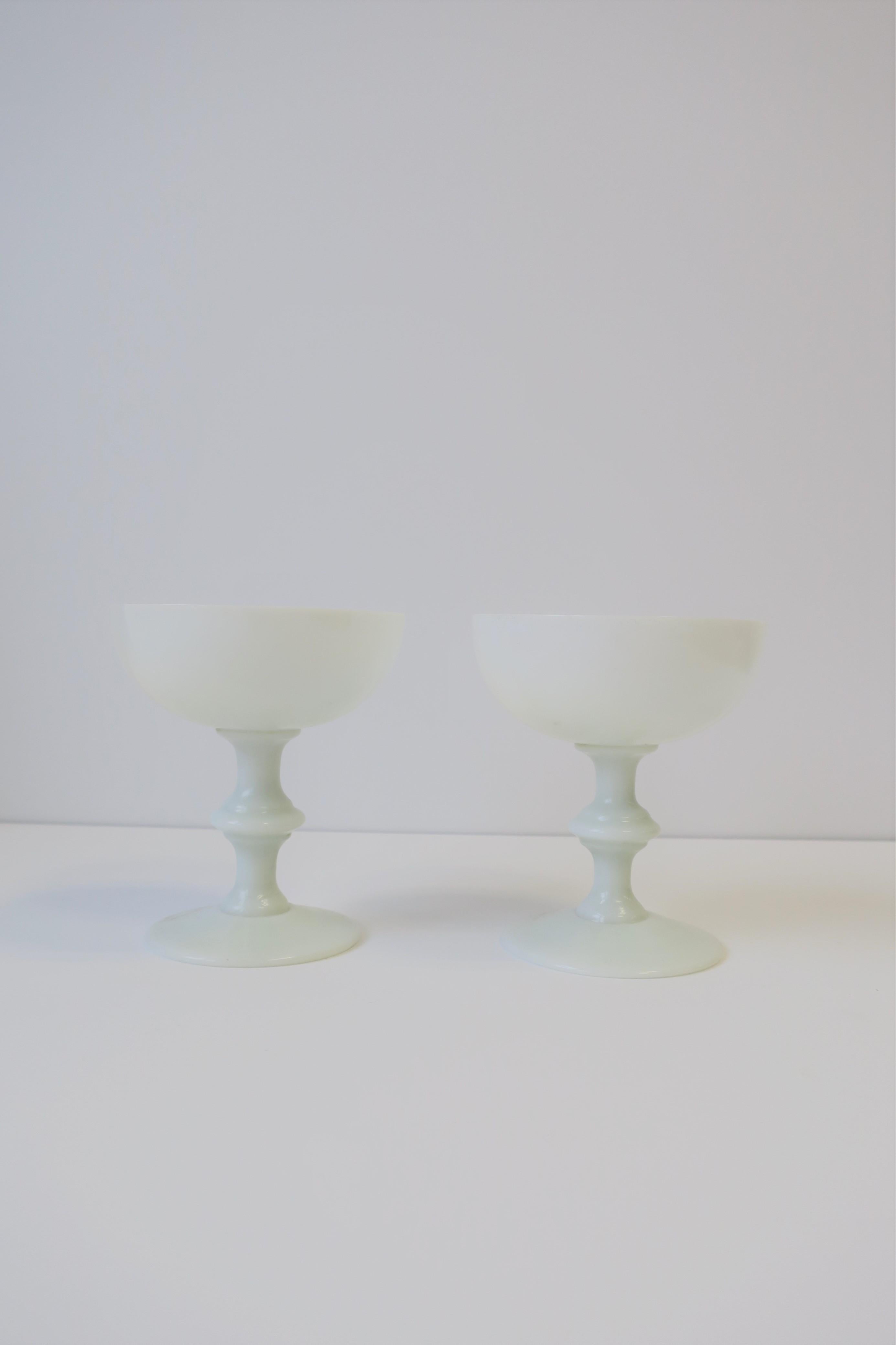 A beautiful pair of French white opaline Champagne glasses by Portieux Vallerysthal, circa early 20th century, France. 
Each glass measures: 4.75