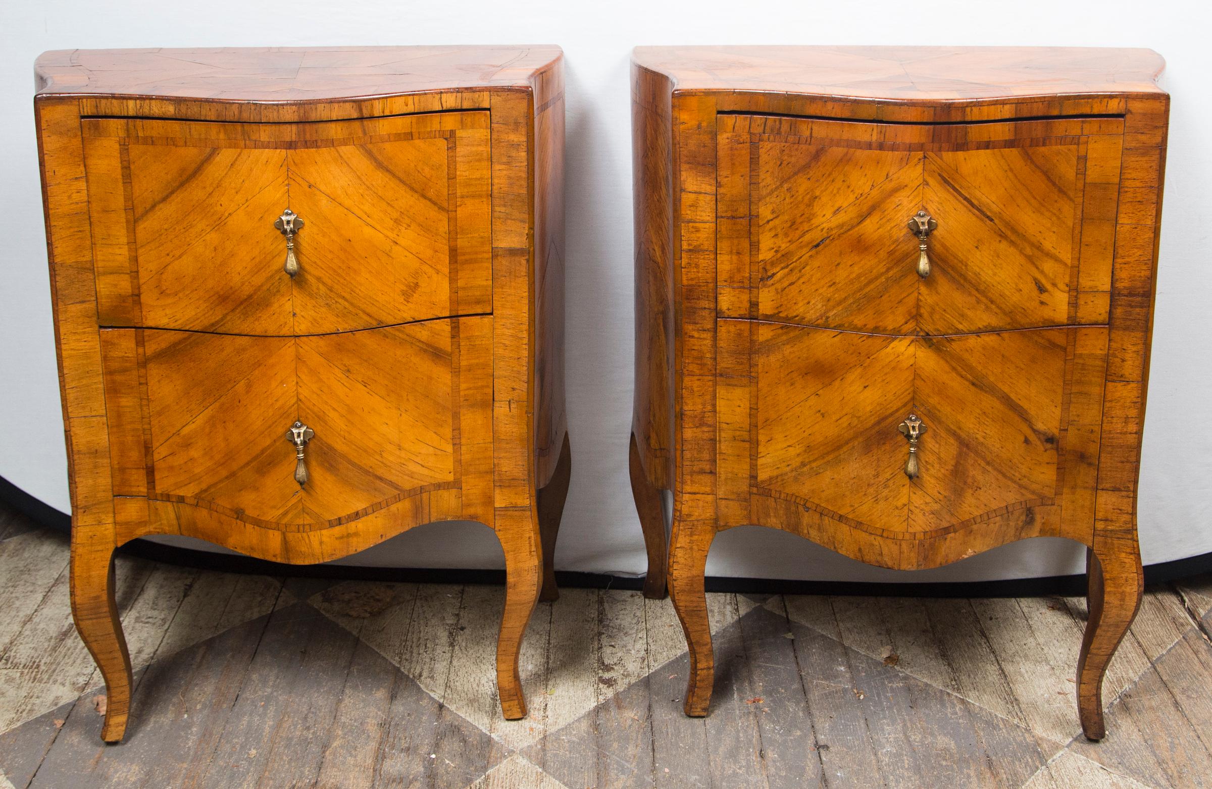 Pair of matching fruitwood (possibly olivewood) parquetry veneers. Each with 2 drawers. Shaped front, rococo legs. Each drawer is 7 inches deep. Drop pulls.