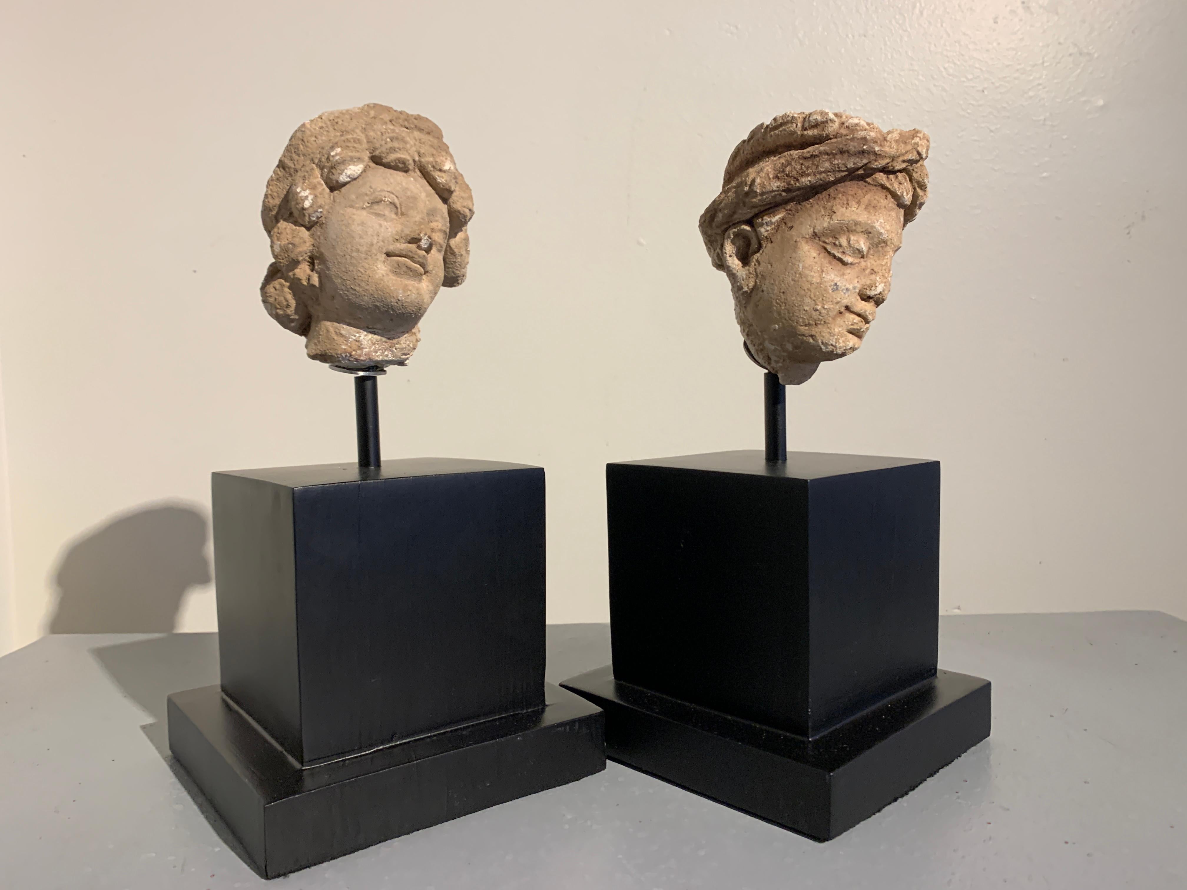 A charming pair of Gandharan molded stucco heads of donors, ancient region of Gandhara (modern day Pakistan / Afghanistan), probably Taxila, circa 3rd-5th century. 

The two heads most likely represent donors. Donors to temples would often have