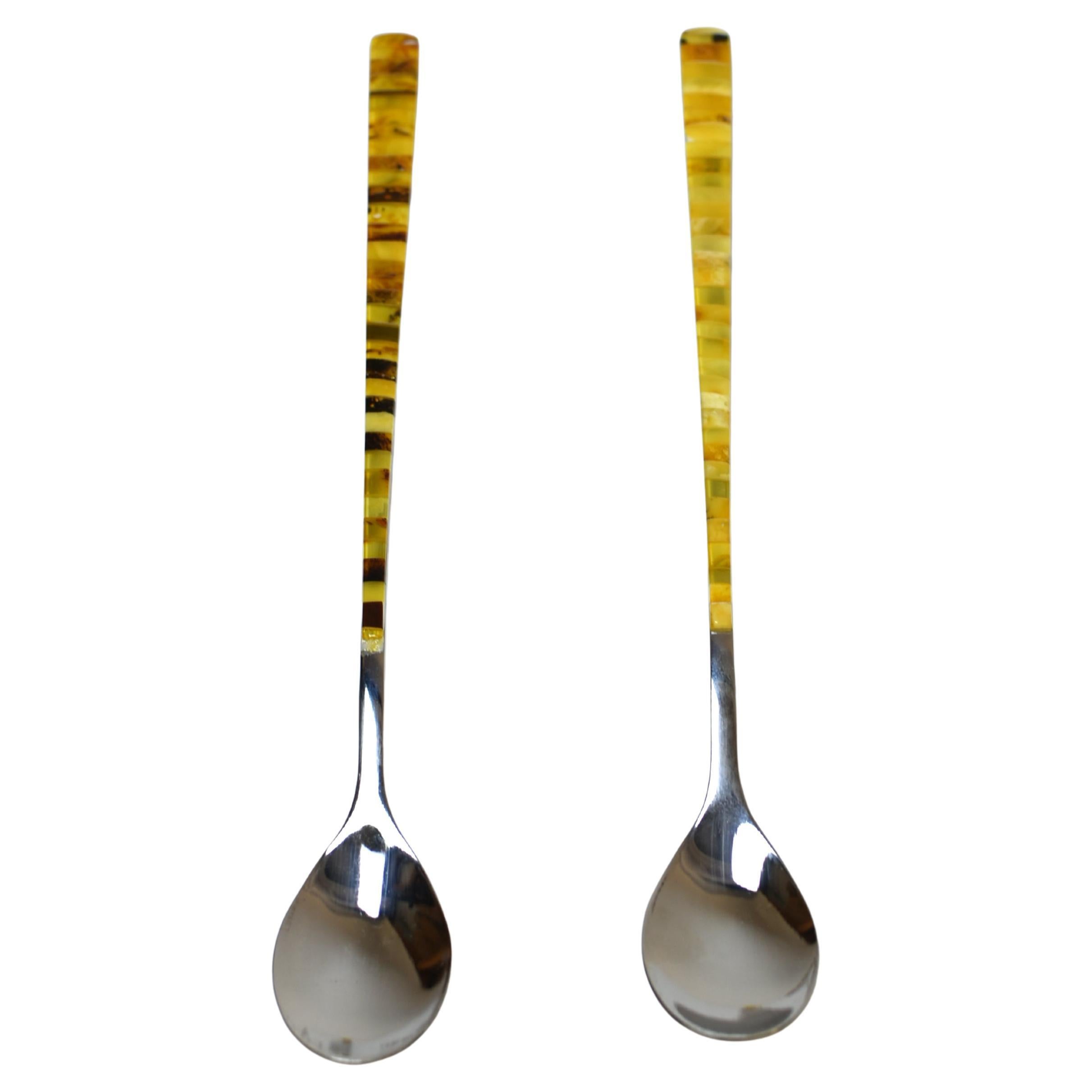 Ti presentiamo una coppia di eleganti cucchiai che fondono perfettamente il design moderno con la bellezza senza tempo delle pietre preziose. Questi pezzi pregiati sono realizzati in solido acciaio inossidabile e offrono una forma snella e