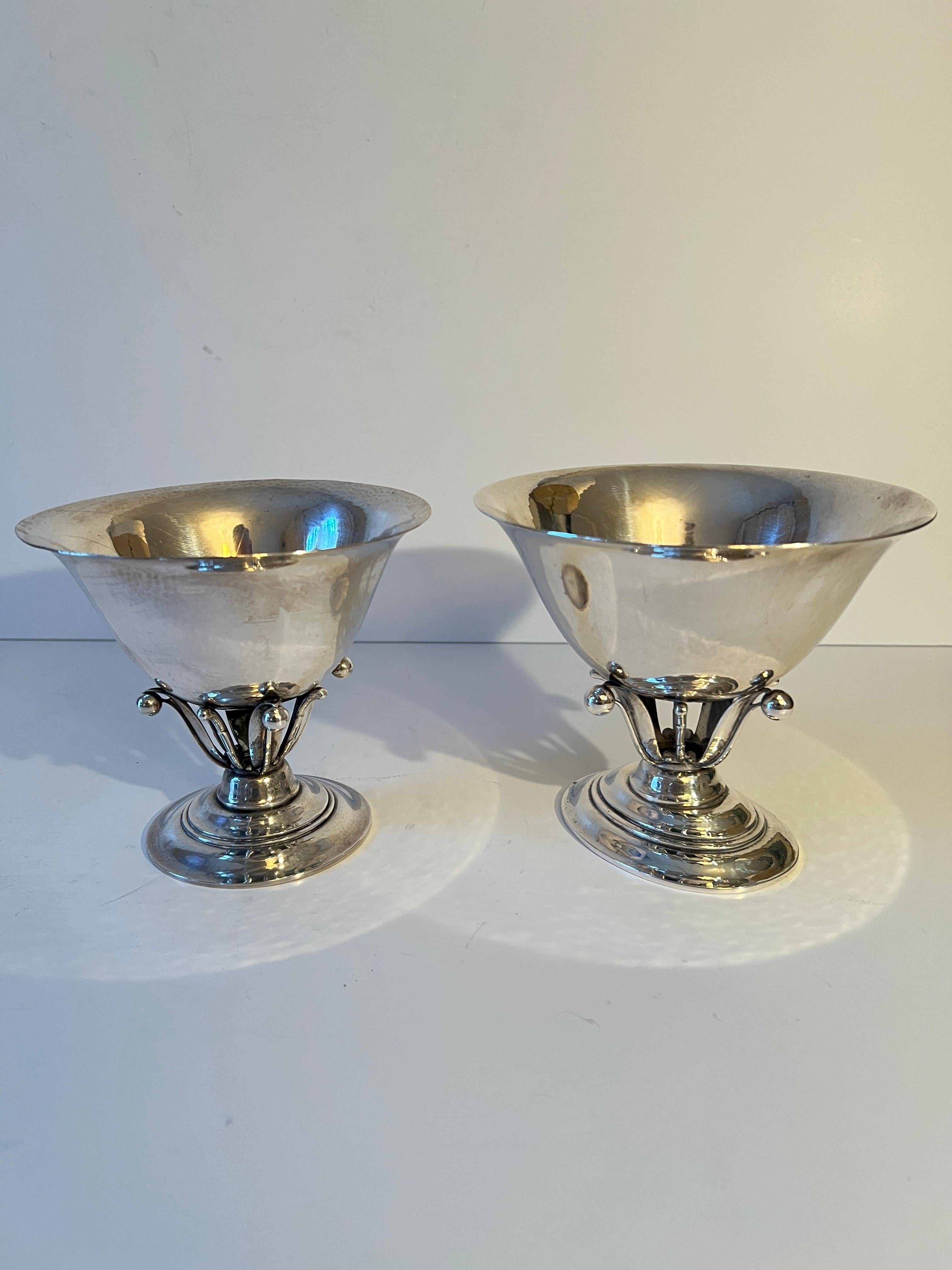 A classic Pair of Georg Jensen style bowls designed by Johan Rohde - the attention to details on the base is exquisite and quite indicative of a Jensen piece.  

A lovely addition to many places - a condiment bowl on the bar, candy dish on the