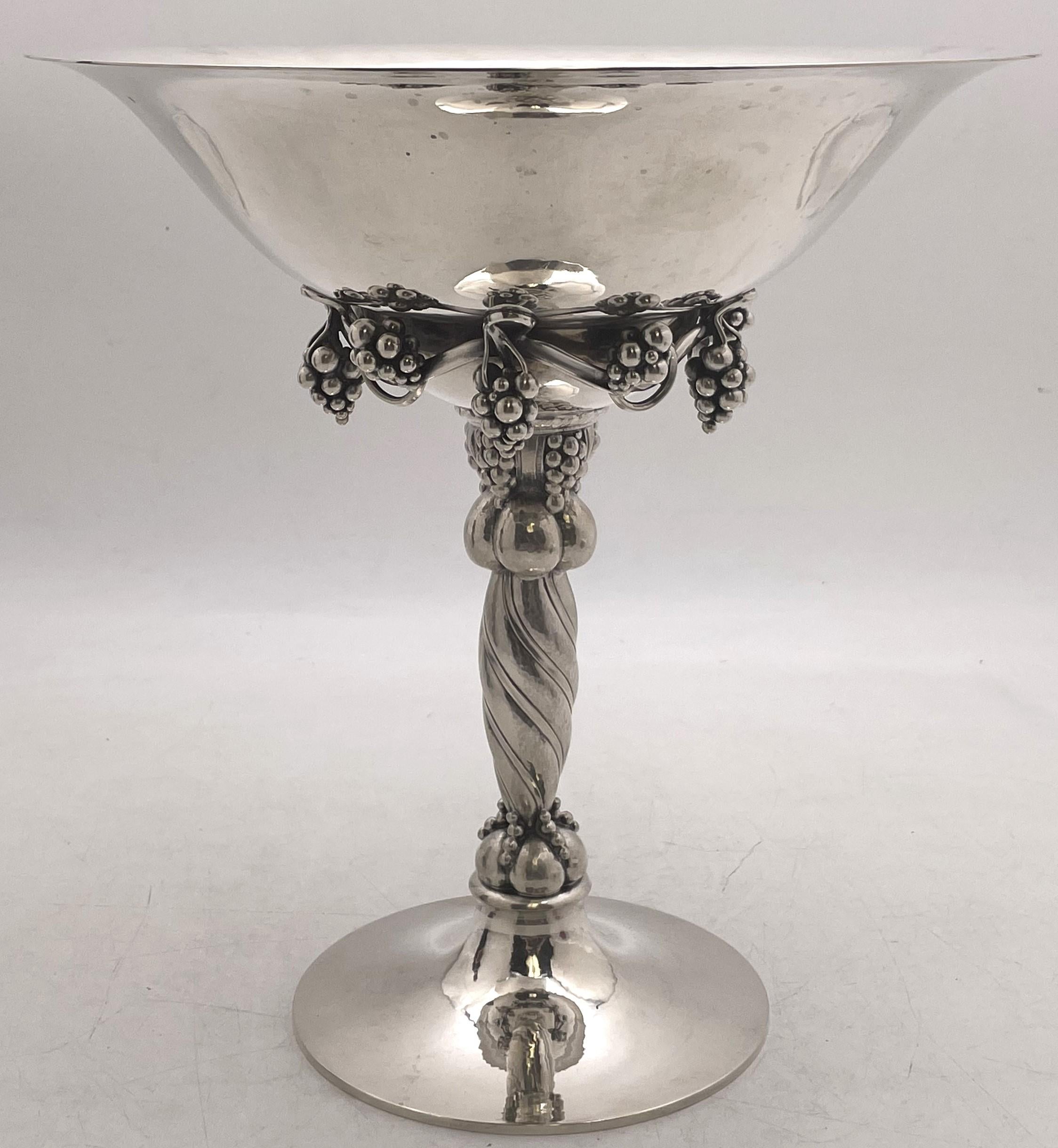 Georg Jensen pair of sterling silver tazzas or compote bowls in the celebrated Grape pattern number 264A, made in the 20th century, beautifully hand hammered and showcasing stylized grape motifs. They measure 10 3/4'' in height by 10 1/8'''' in