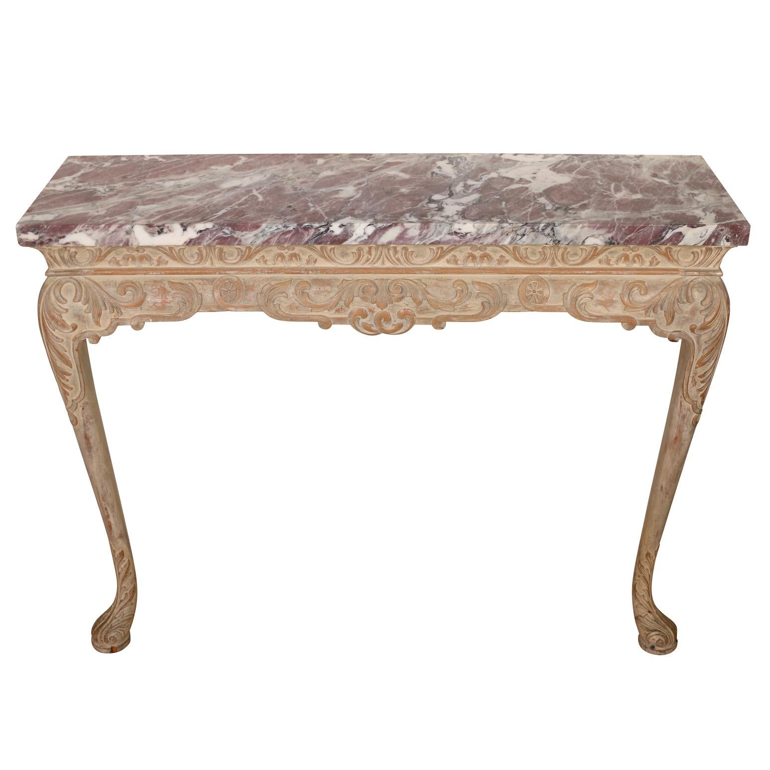 A pair of George I style, wall mount pier tables with carved and painted legs and apron, and a rose colored marble top.