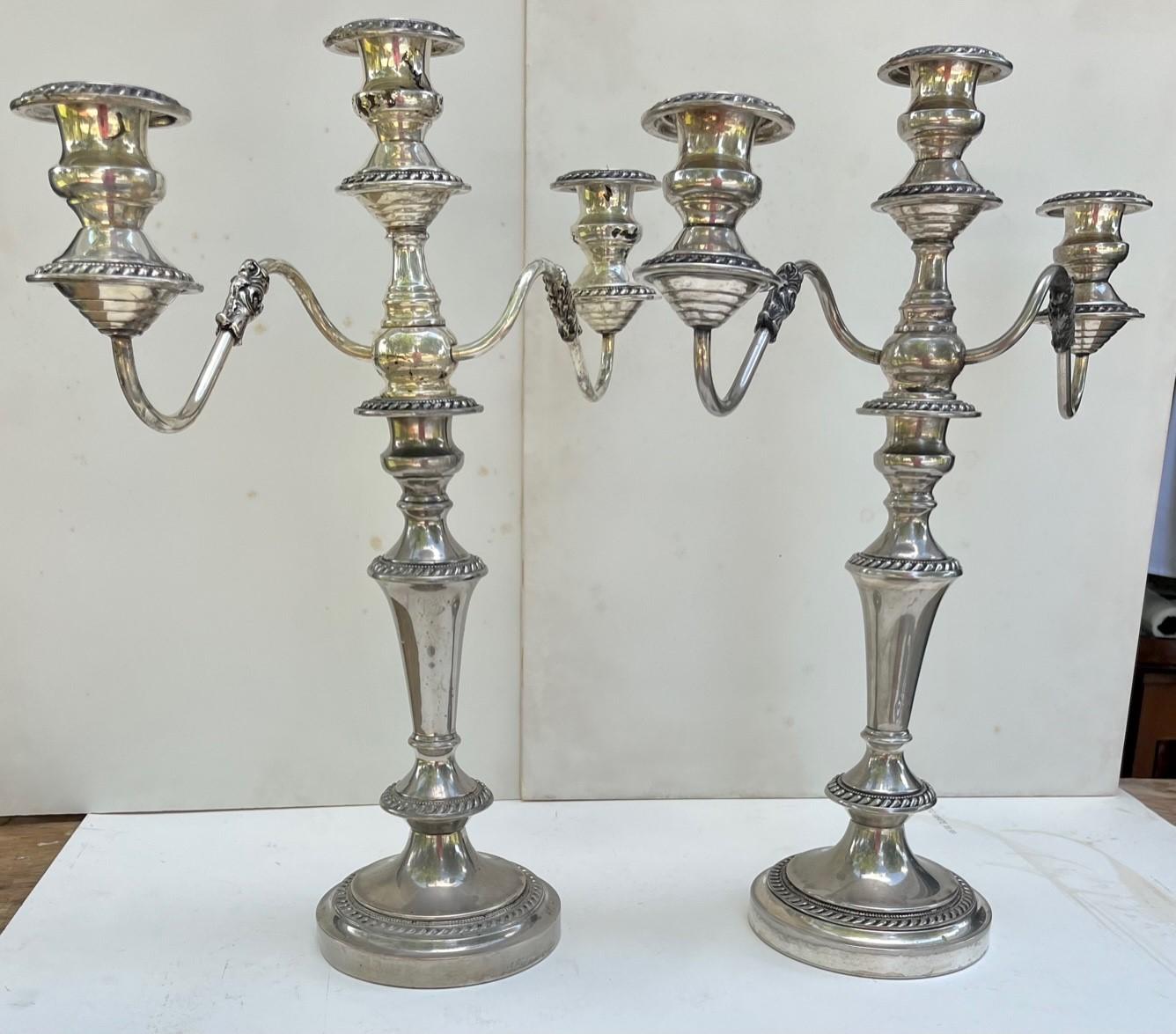 Pair George III Old Sheffield Silver Plated Three Light Candelabras.

Elegant pair of 19th century Georgian Sheffield Silver Plate three light Candelabra with twin scroll arms. Each has three sconces and detachable nozzles. The arms can be removed
