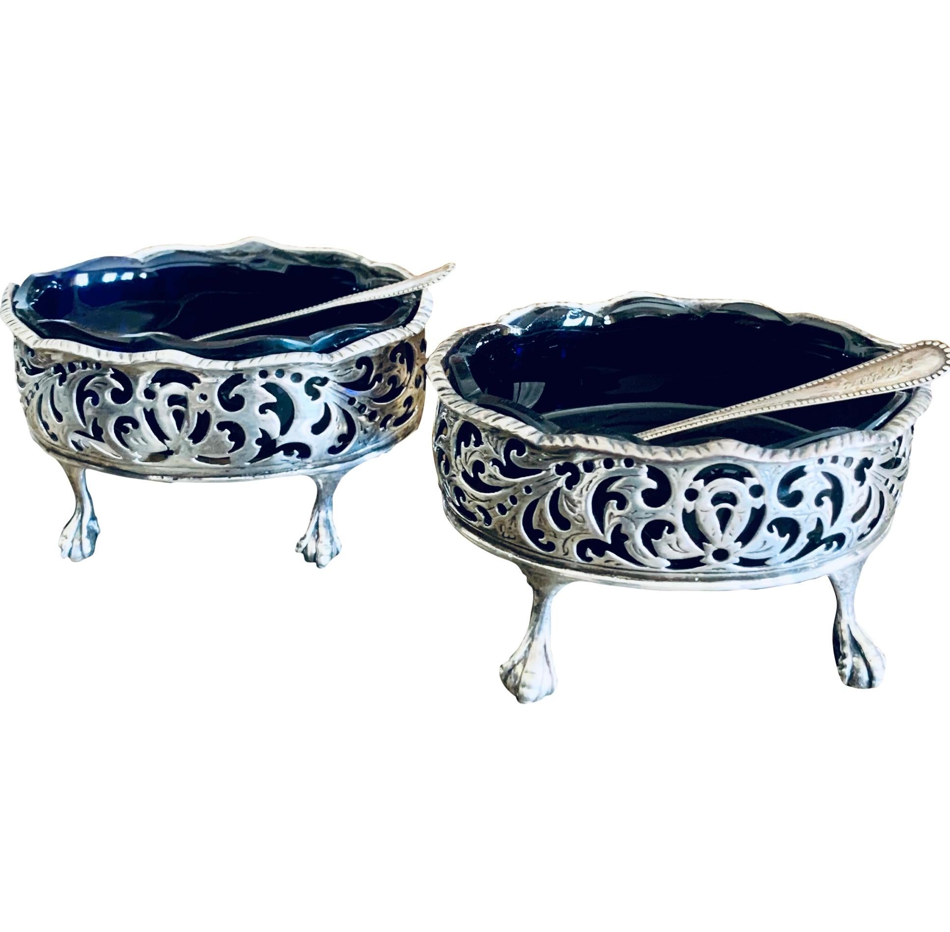 A very elegant pair of sterling salt cellars, date marked 1769, made by London father and son silversmith team David Hennell I (1712- 1785) and Robert Hennell I (1741-1811).  Lovely openwork Rococo scrolls form the ovalbody of each salt cellar which
