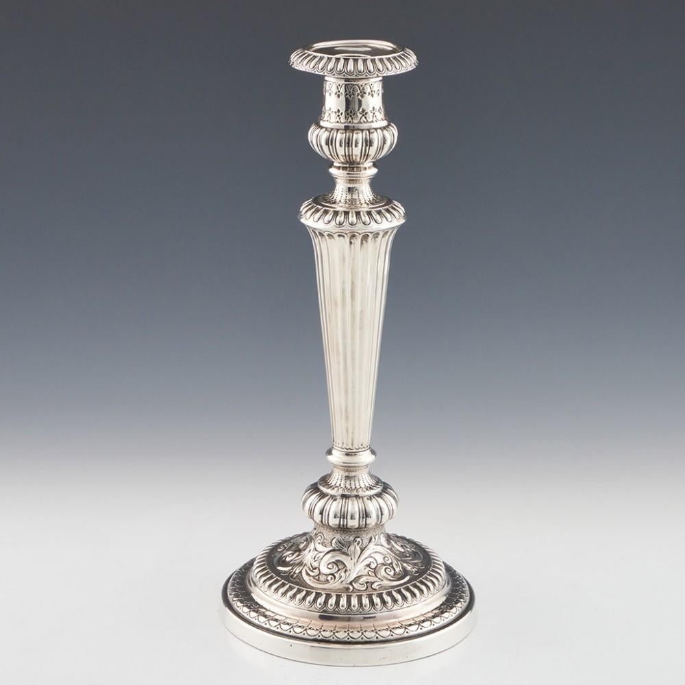 Heading : Pair of George IV silver candlesticks 
Date : Hallmarked in 1826 in Sheffield for James Kirby & Co
Period : George IV
Origin : Sheffield,Yorkshire, England
Decoration : Reeded sconces and body, bell shape capitals with engraved swags to
