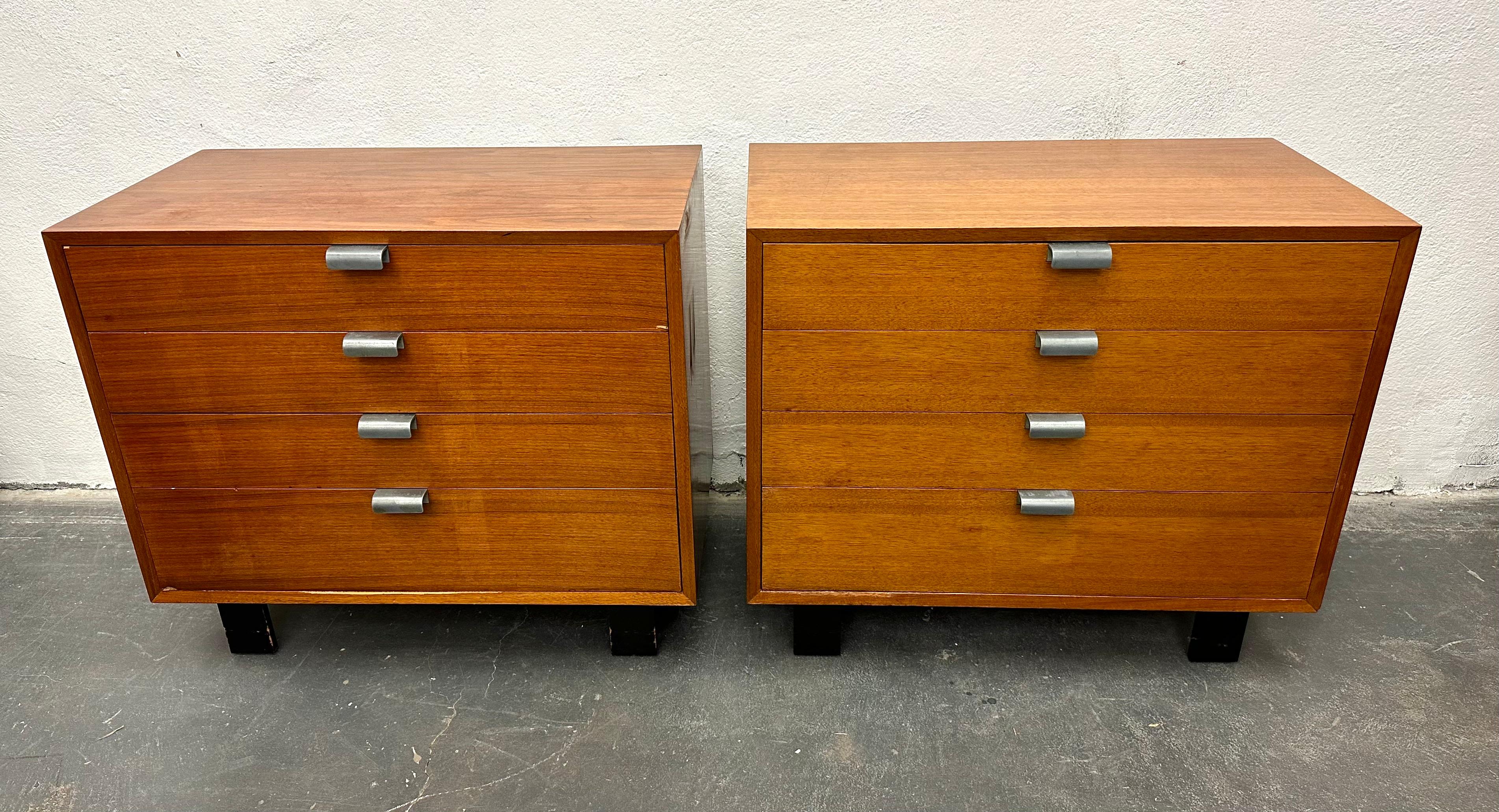 Simple elegant modern walnut chest of drawers with ebonized wood legs and aluminum pulls, c. 1950. The original finish has a warm patina and even color. For Herman Miller, Retains aluminum foil manufacturers label.
 