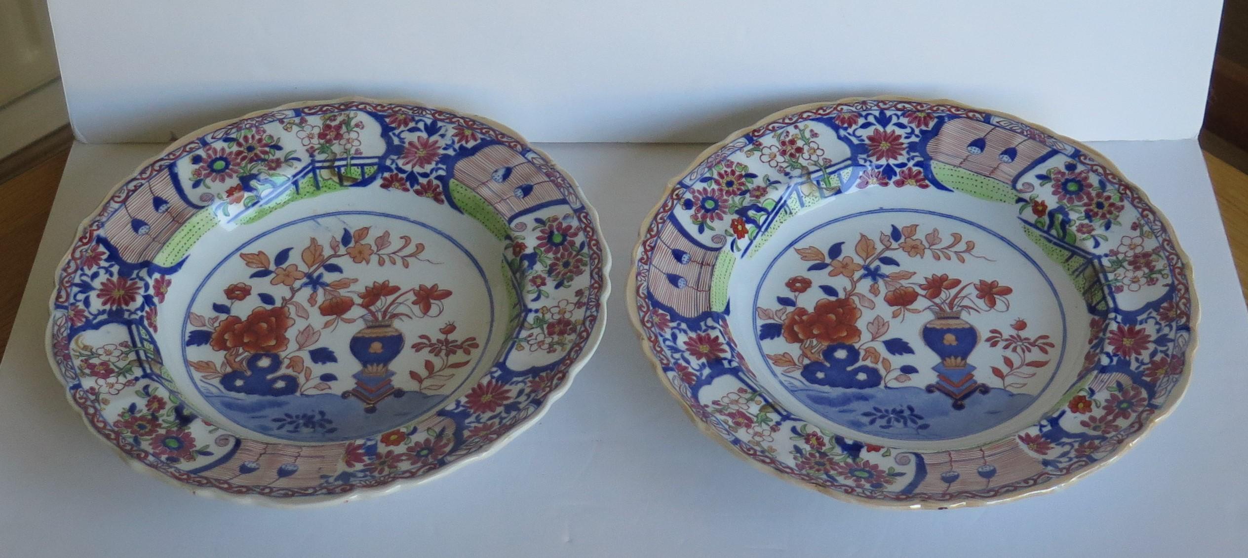 This is an early and very decorative pair of ironstone pottery large soup bowls or deep plates, a produced by the Mason's factory at Lane Delph, Staffordshire, England, circa 1815 to 1820.

The plates are circular with a slightly fluted outer rim