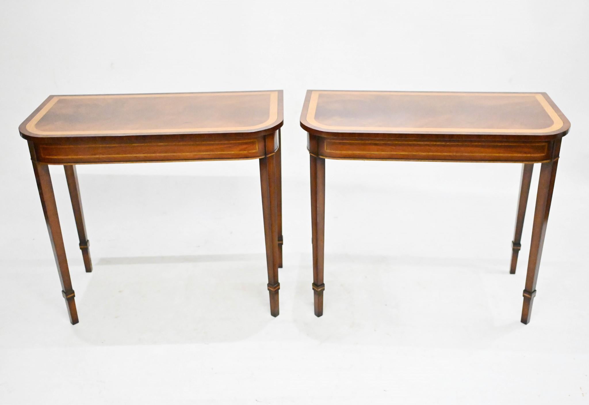 Pair of classic console tables in the Georgian manner
Feature distinctive D ends 
Hand crafted from mahogany with crossbanded tops using satinwood
Classically refined design with tapered legs - perfect for contemporary interiors
Offered in great